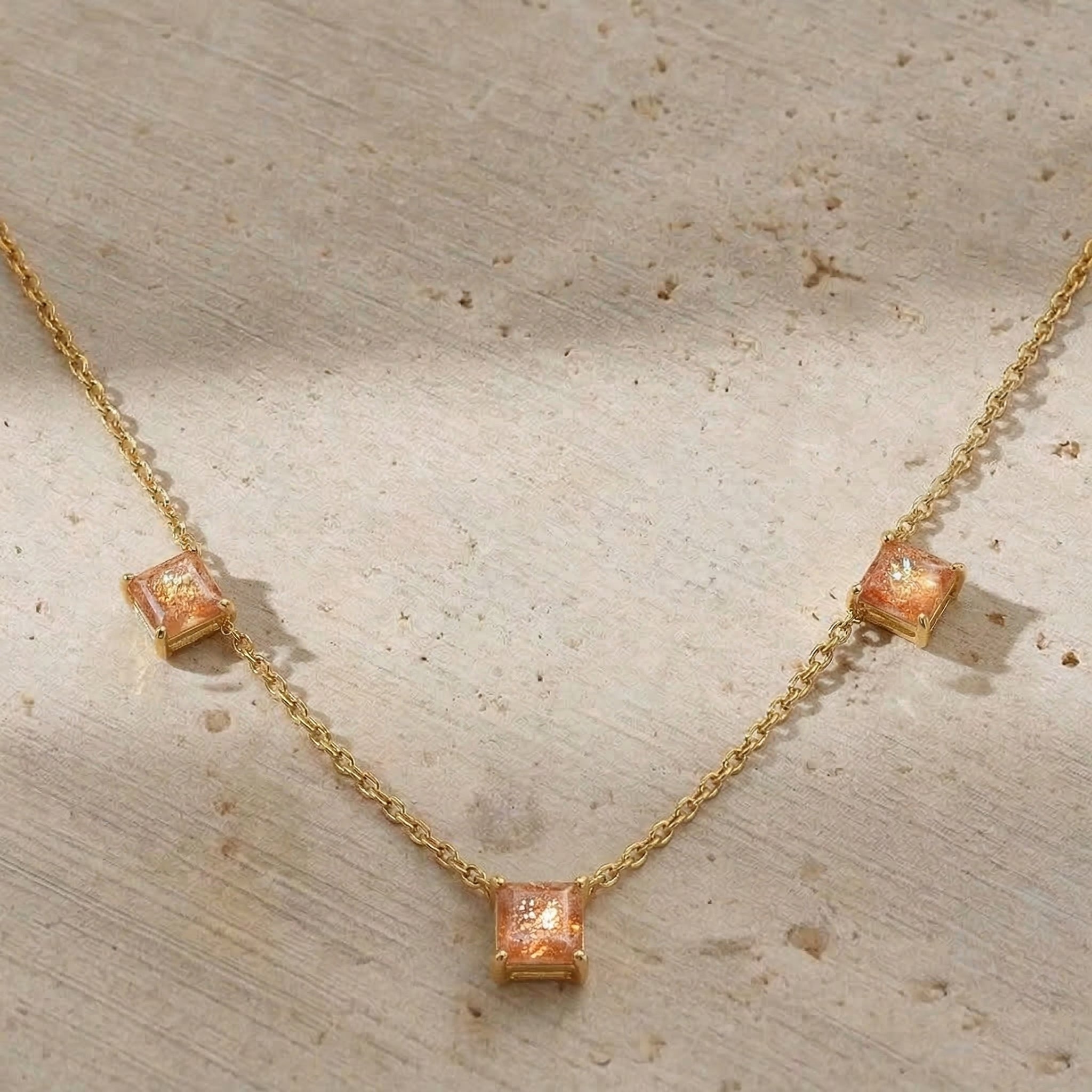 Golden orange gemstone necklace with natural Sunstone stones and modern station design.
