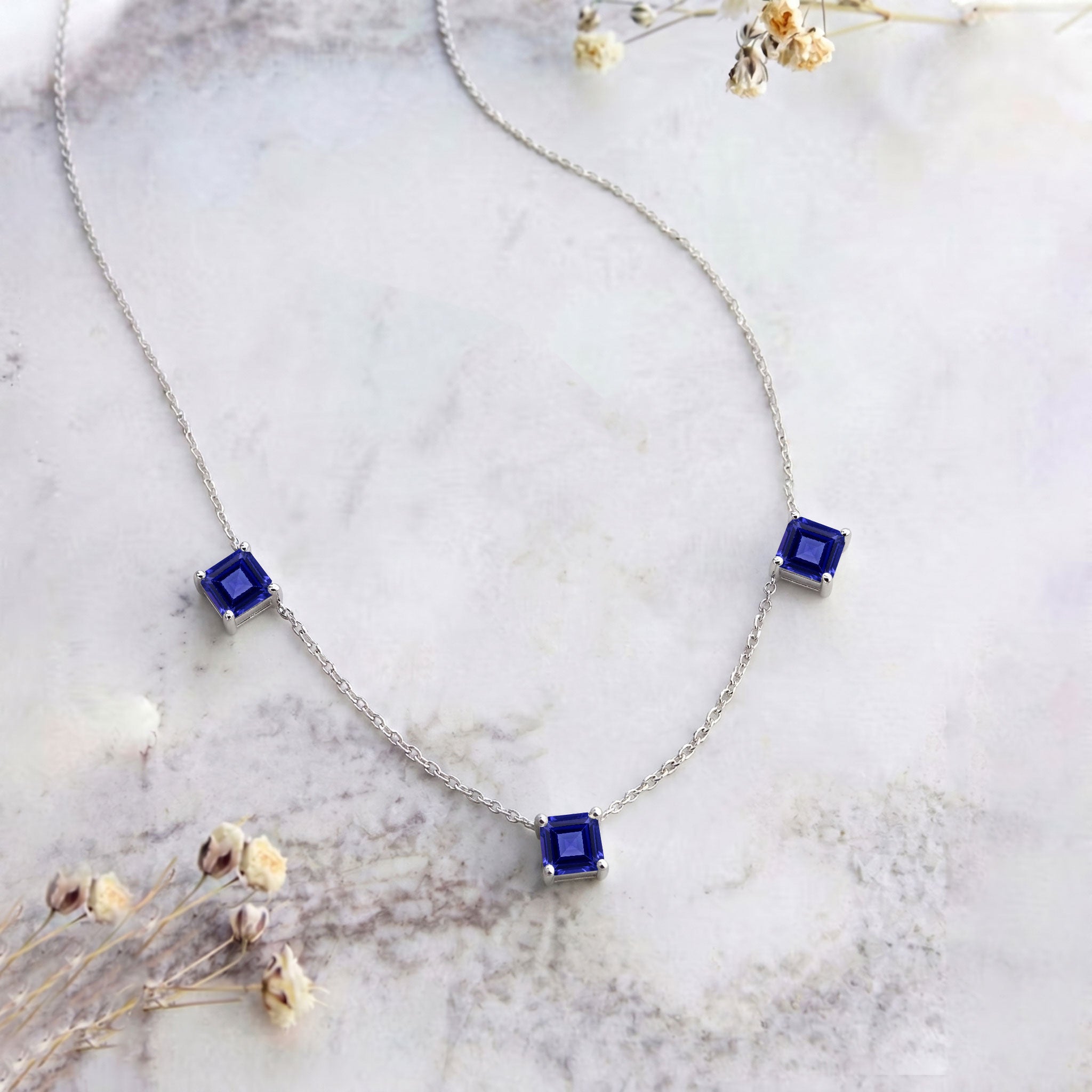 Dainty Tanzanite gemstone necklace with blue violet stones and yellow gold filled finish.
