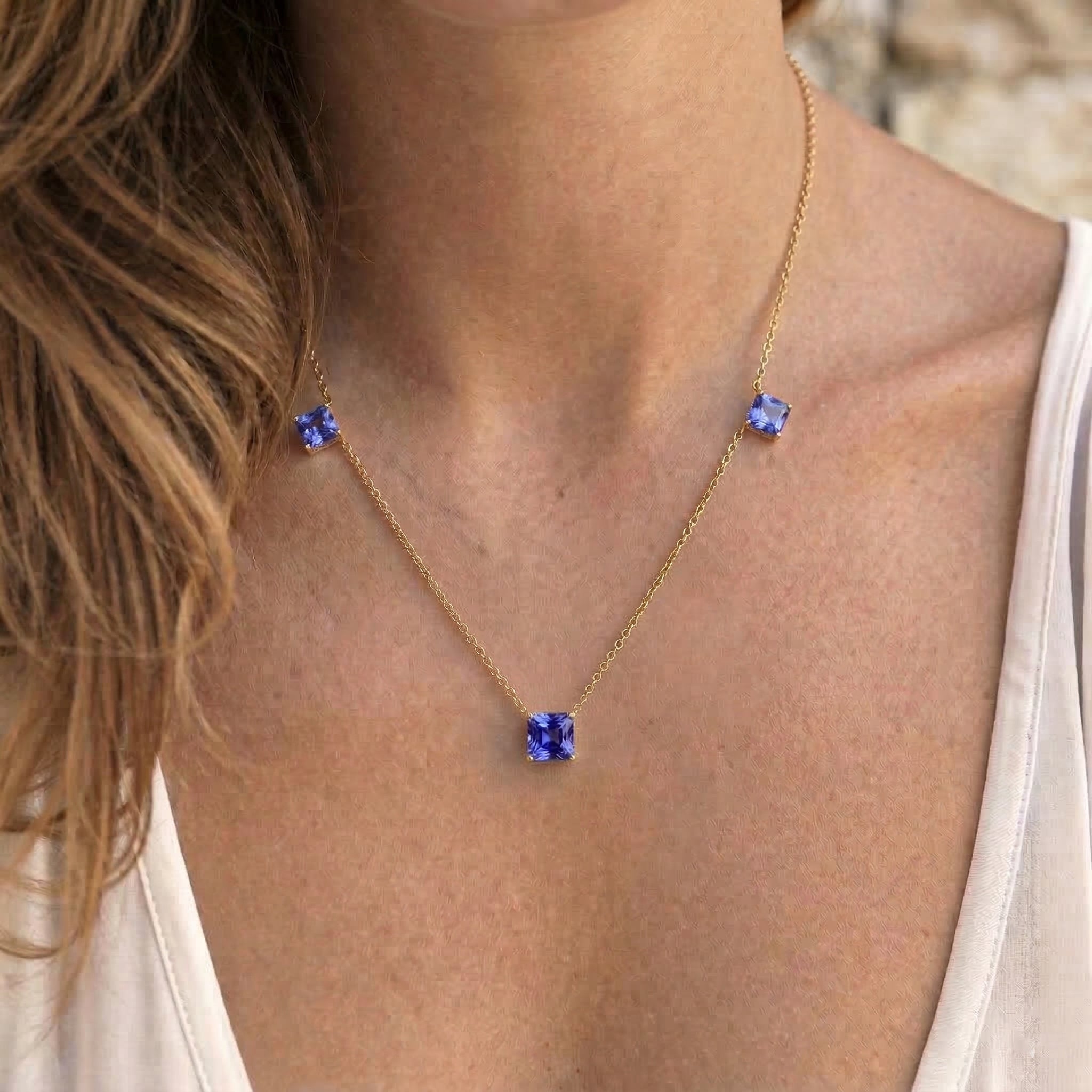 Tanzanite gemstone necklace with elegant three stone design.
