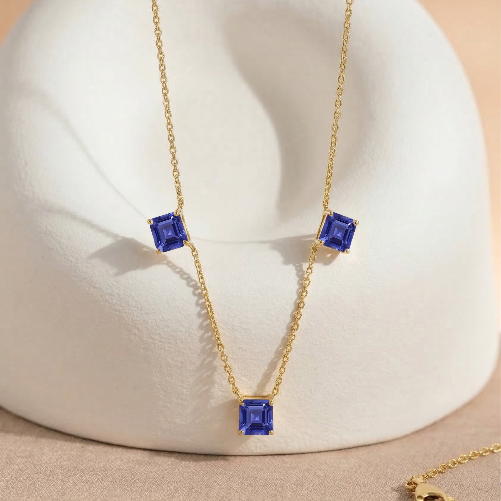 December birthstone Tanzanite necklace with elegant three stone design for women.
