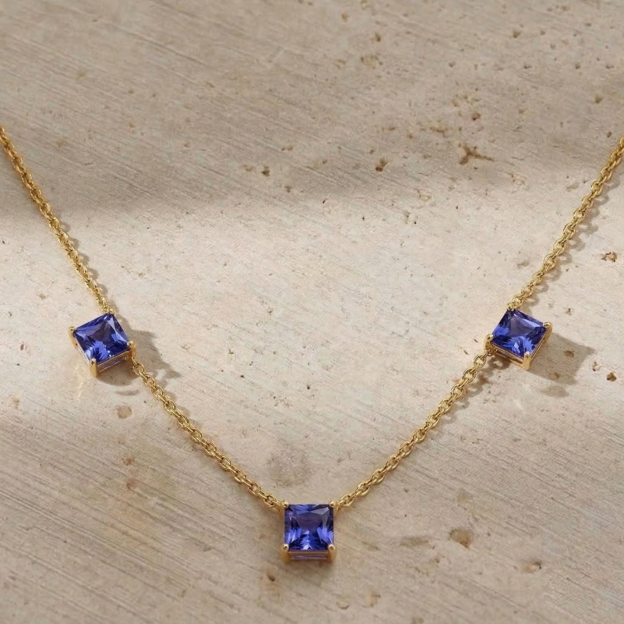 Asscher cut Tanzanite necklace with yellow gold filled finish.
