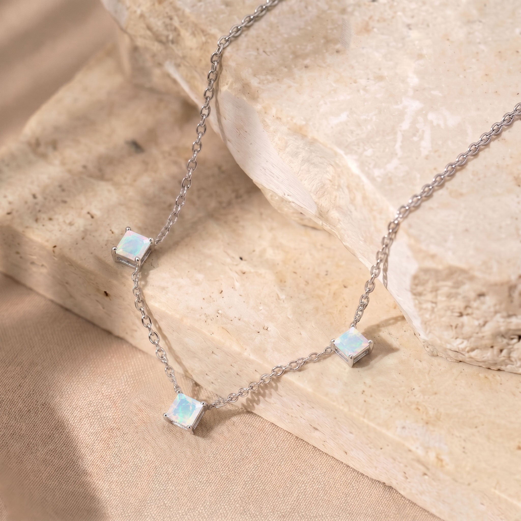 Dainty Natural White Opal gemstone necklace with luminous opal stones and yellow gold filled finish.
