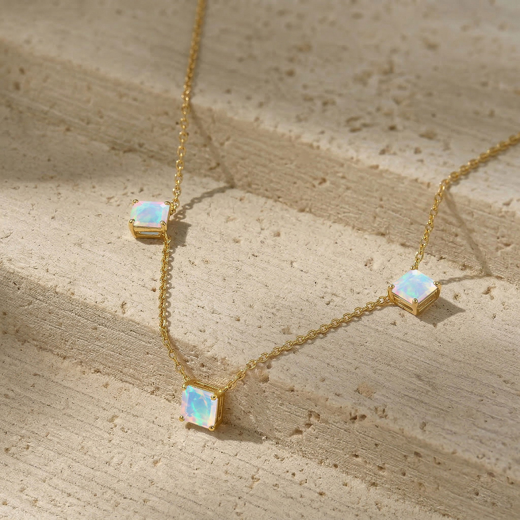 Iridescent white gemstone necklace with natural opal stones and modern station necklace design.
