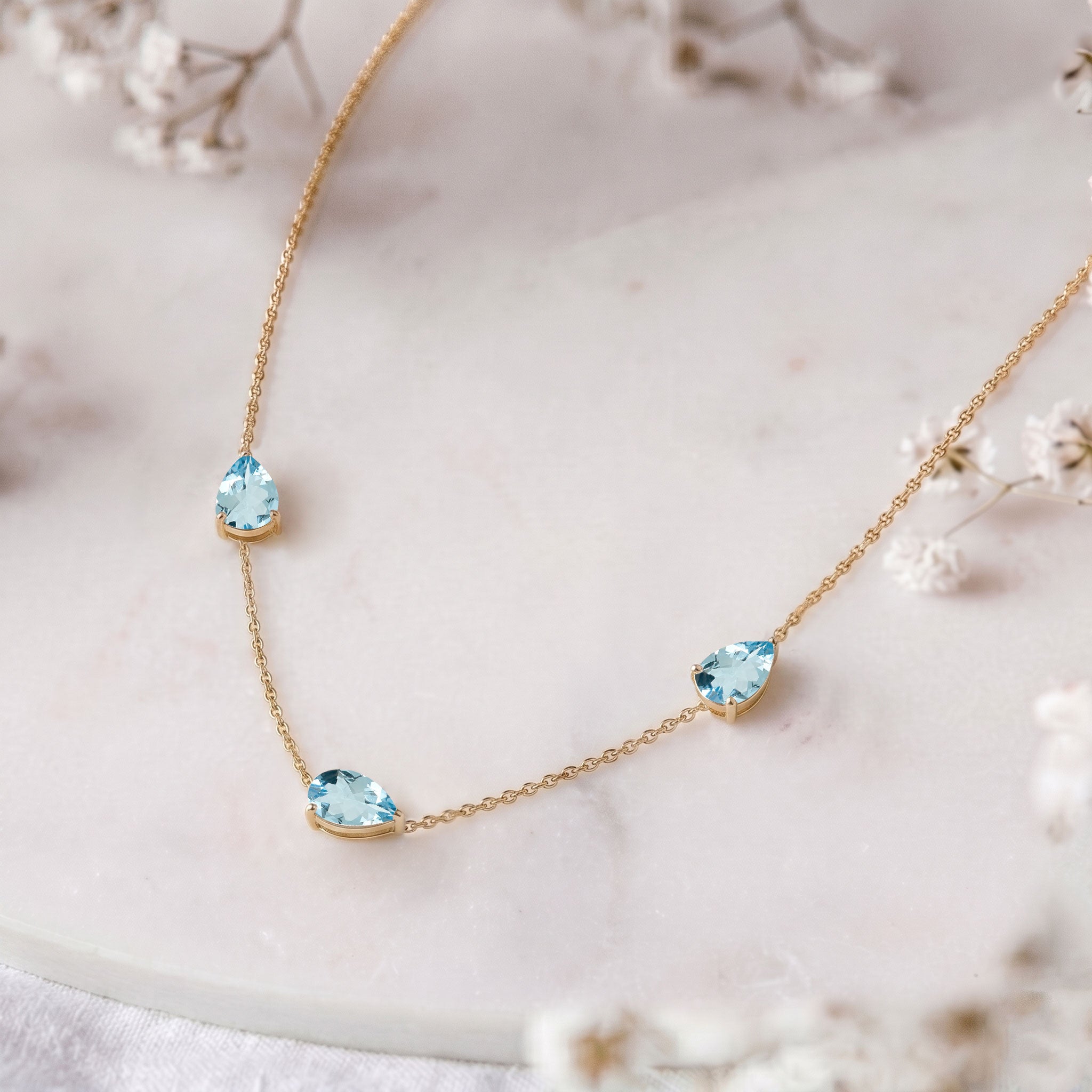 Three stone Aquamarine necklace symbolizing timeless elegance and beauty
