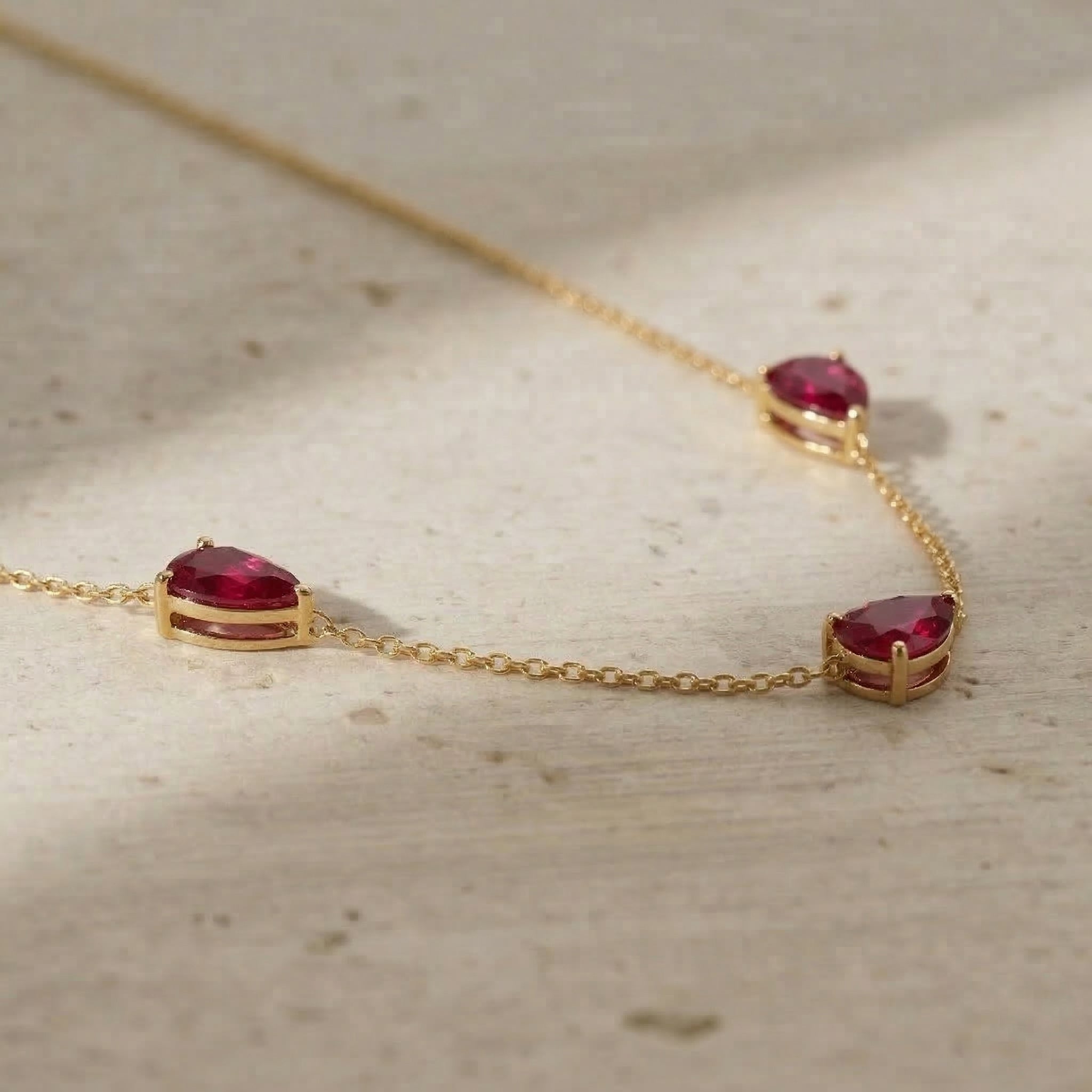 Fine jewelry ruby necklace with three pear cut stones measuring 8x6 MM and elegant pendant style
