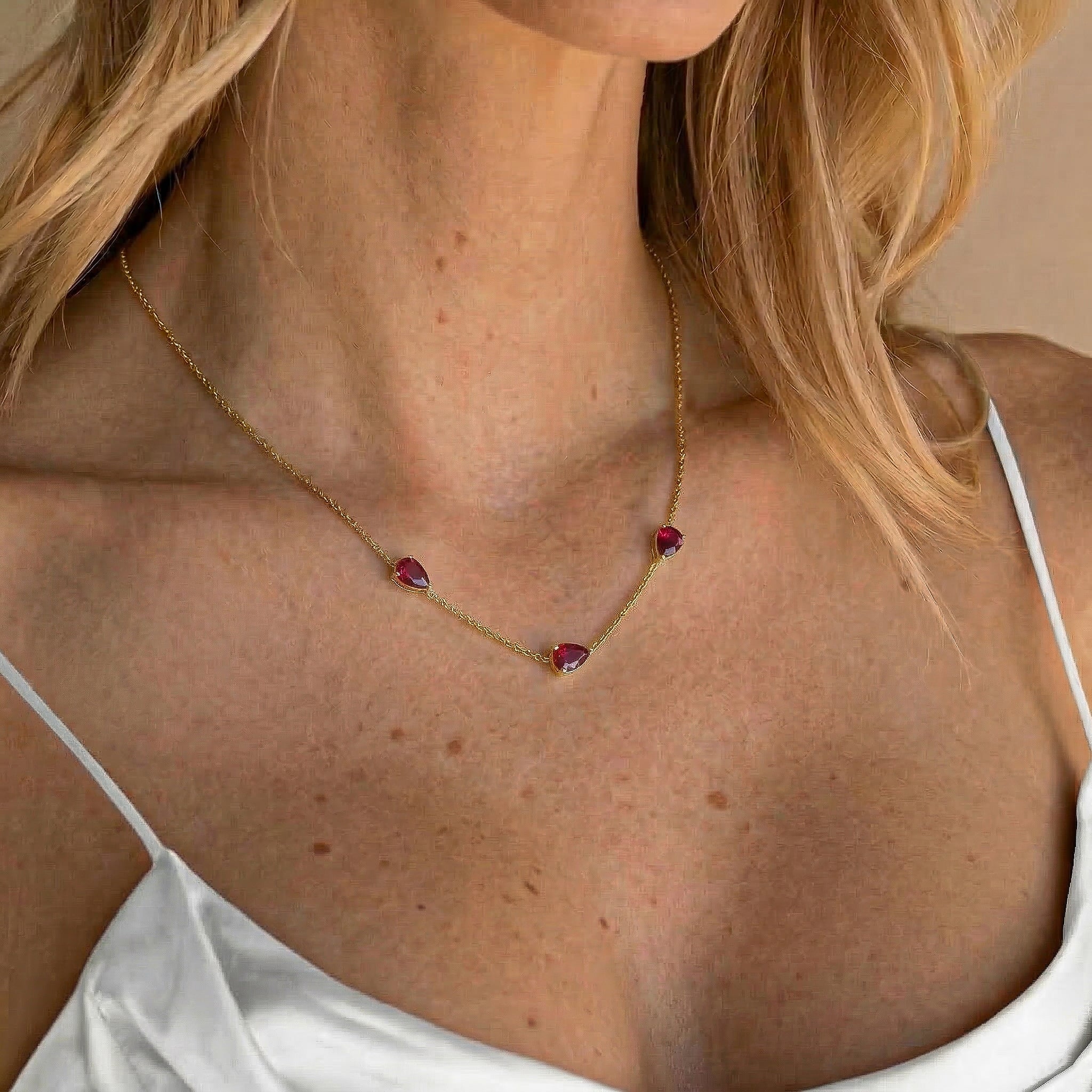 Dainty ruby birthstone necklace with three pear cut gemstones perfect for everyday wear and special occasions
