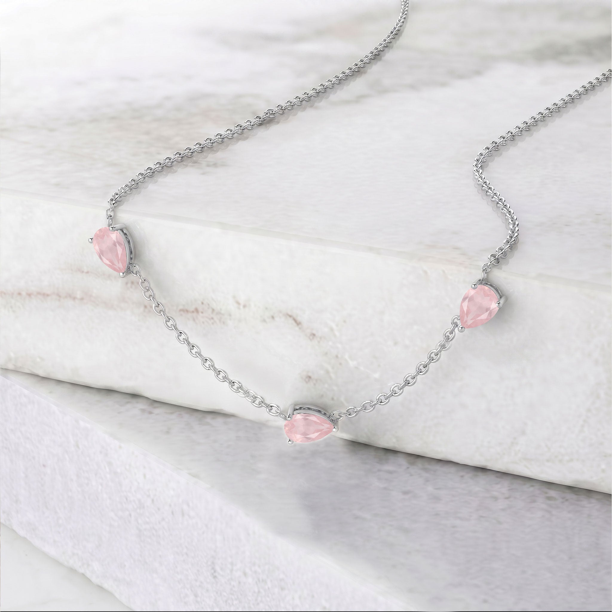 Elegant three stone rose quartz pear-cut necklace crafted in 925 sterling silver with yellow gold filled option.
