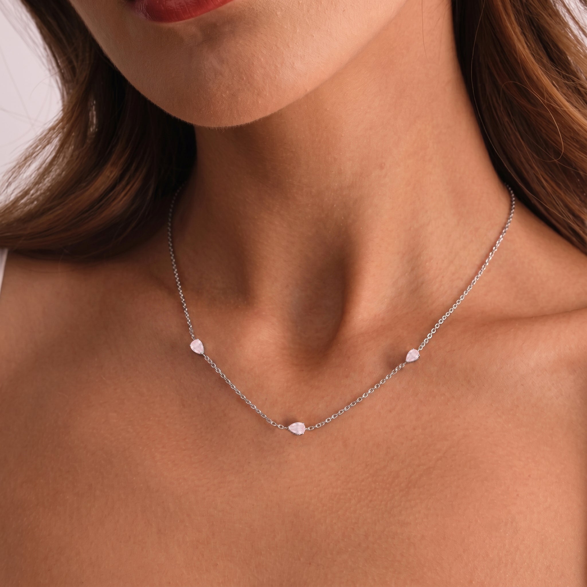 Romantic rose quartz necklace with three pear-cut stones in dainty station design.
