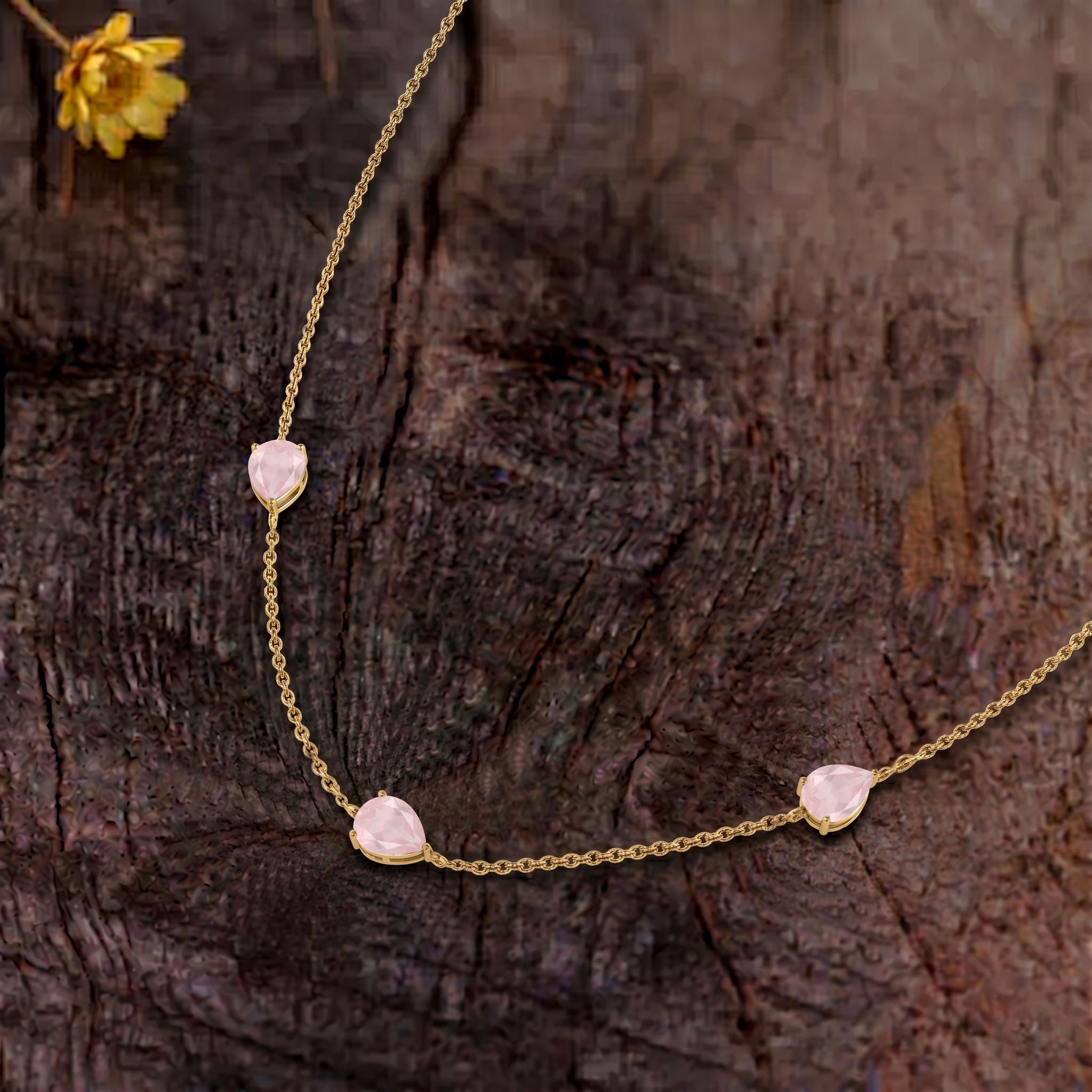 Feminine rose quartz necklace featuring natural pear-cut gemstones in sterling silver.
