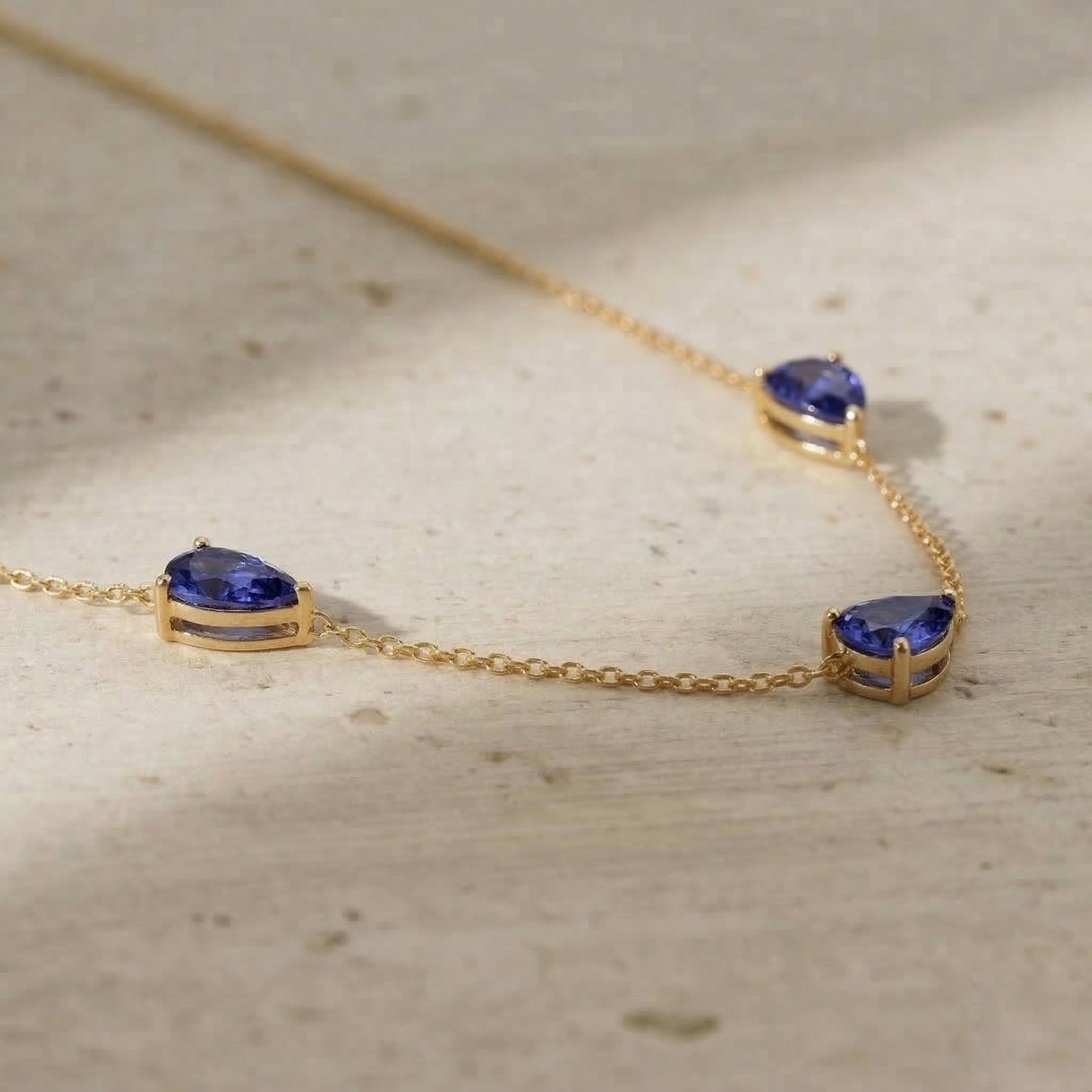 Fine jewelry Tanzanite necklace with three pear cut stones measuring 8x6 MM for elegant everyday wear
