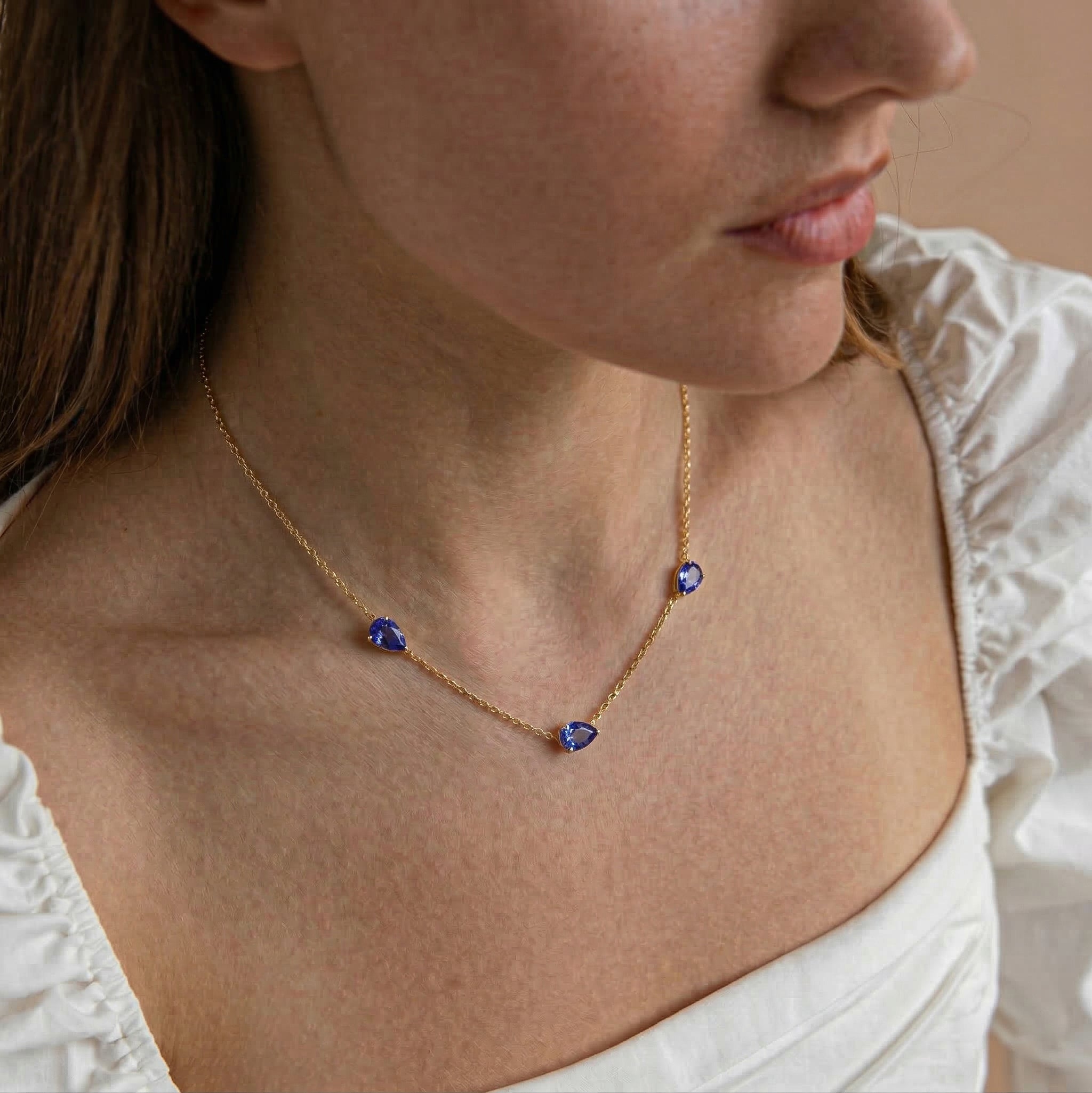 Beautiful pear shaped Tanzanite necklace with rare blue purple gemstone sparkle and minimalist style
