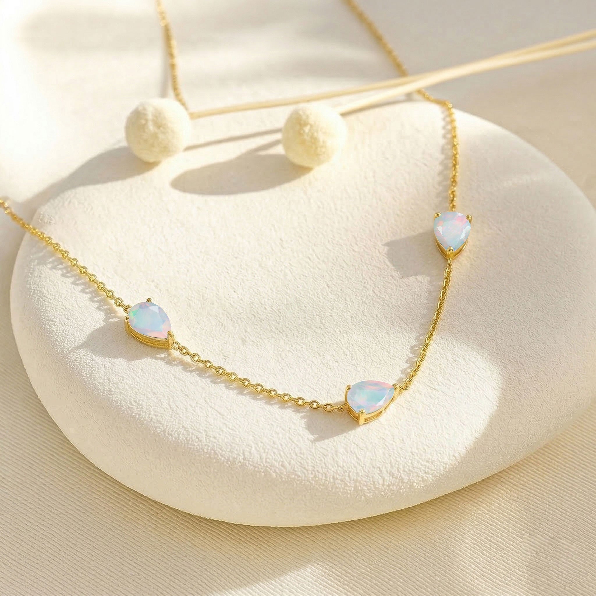Natural white opal pendant necklace with soft glowing gemstones and elegant sterling silver chain design
