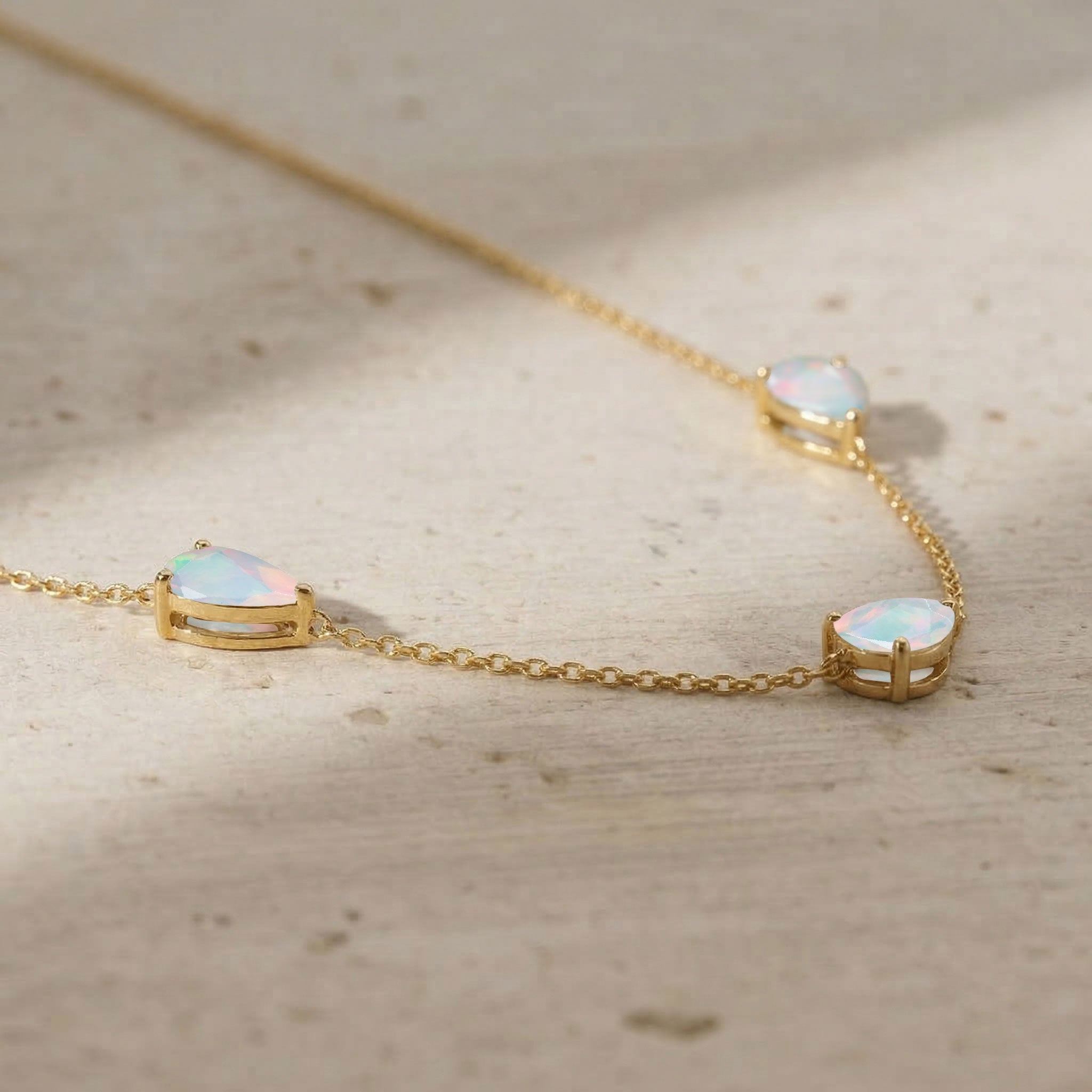 Fine jewelry white opal necklace featuring three pear cut stones measuring 8x6 MM
