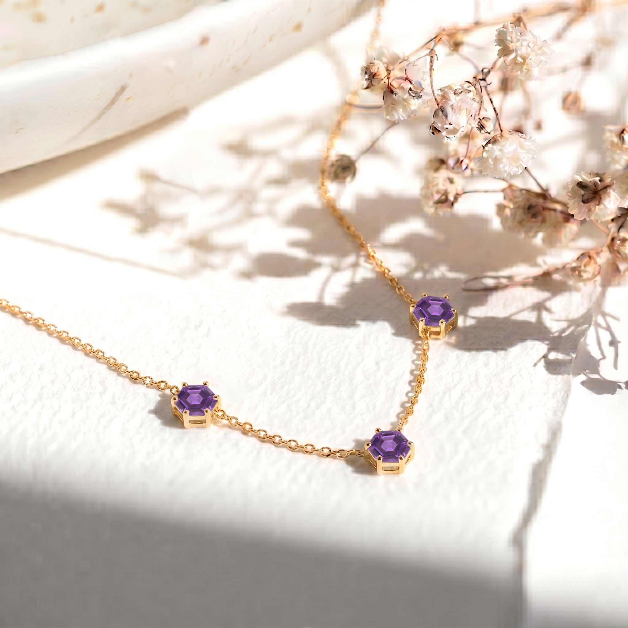 Sterling silver Amethyst layering necklace with geometric gemstones.

