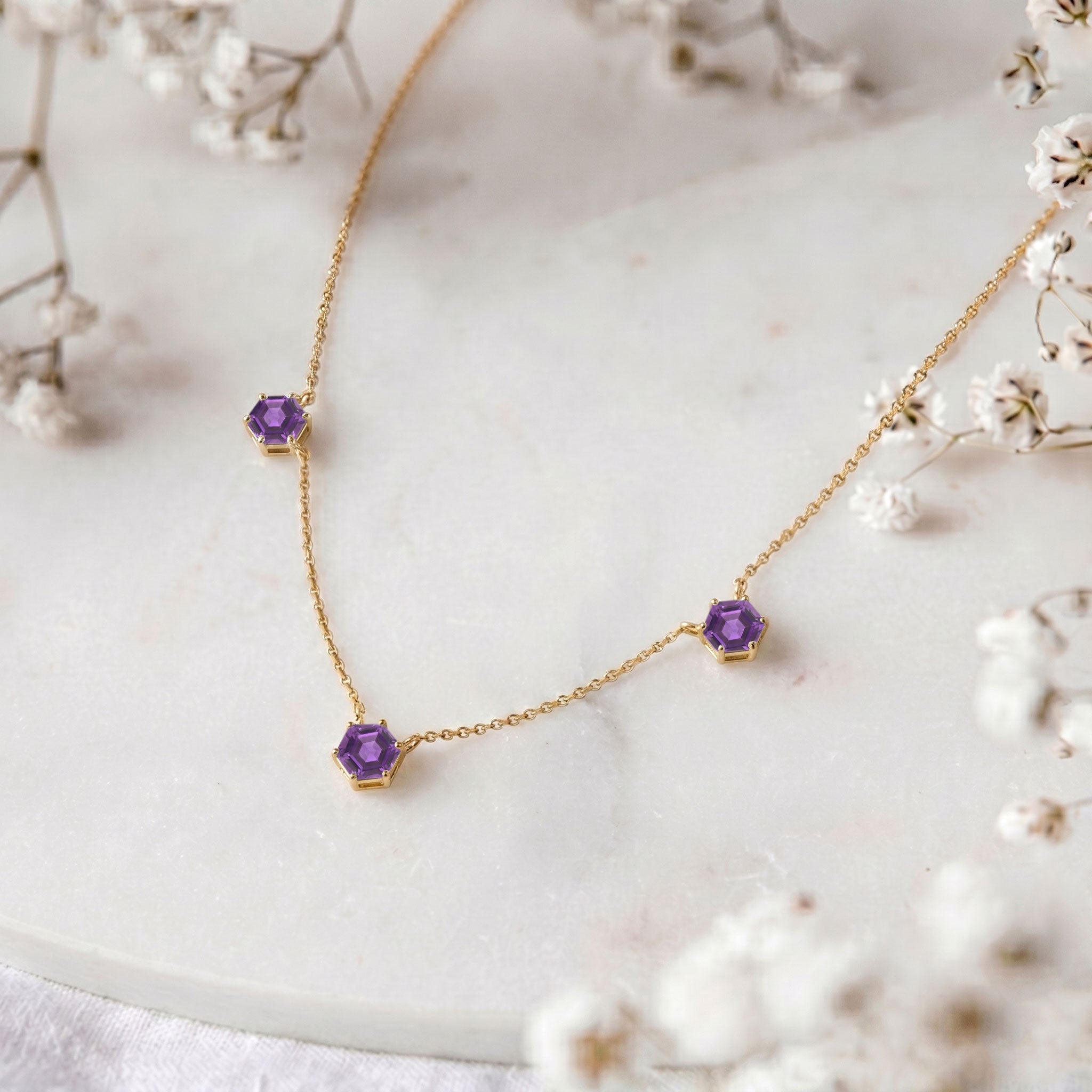 Purple Amethyst gemstone necklace with three hexagon stones.
