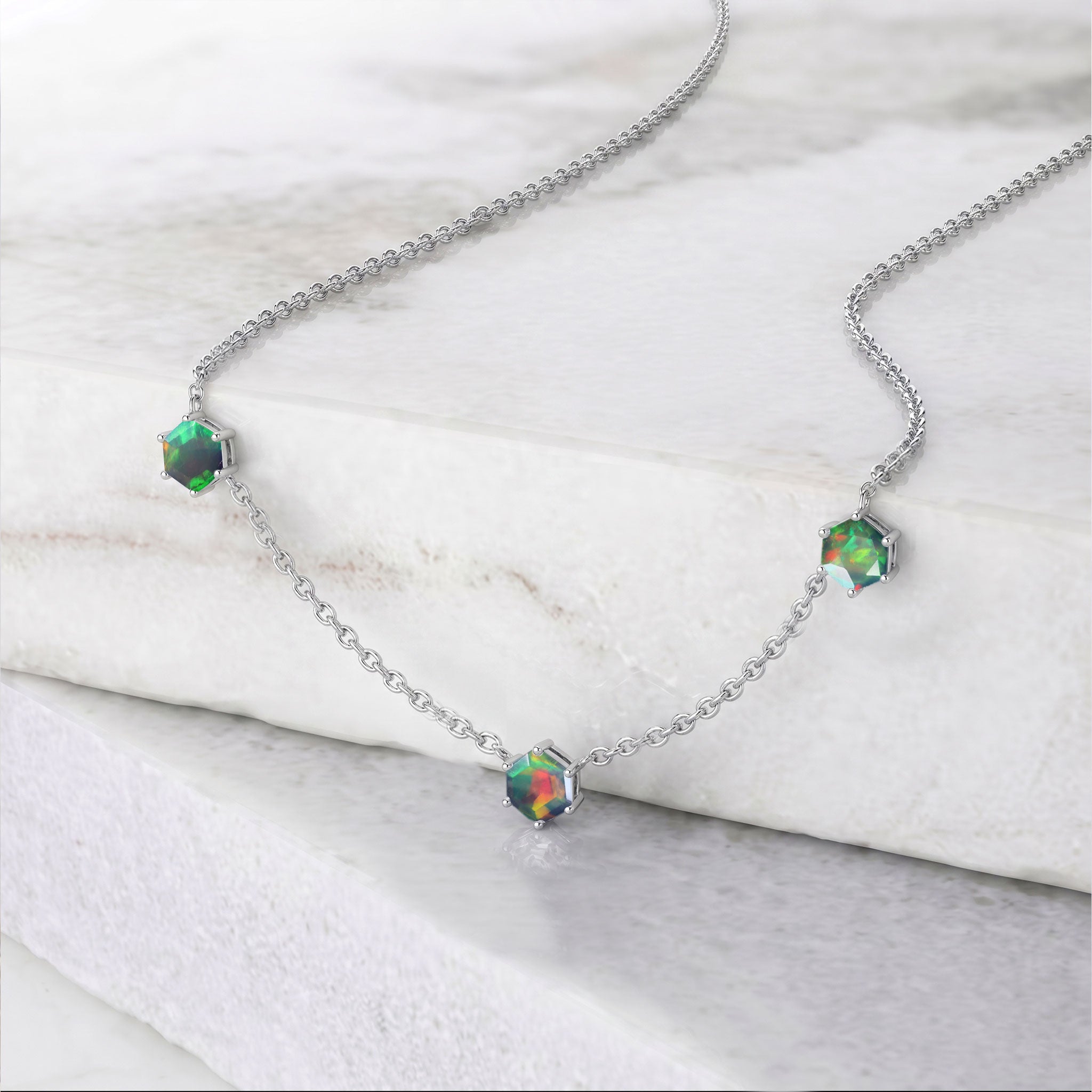 Three stone black opal gemstone necklace with vibrant color play, modern station design, and adjustable chain
