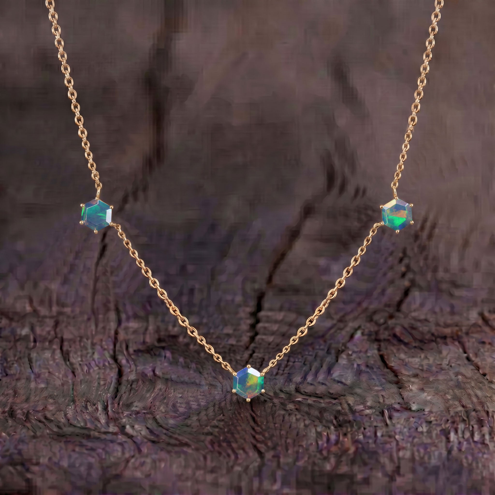 Luxury black opal necklace for women featuring three hexagon shaped opal stones set in sterling silver jewelry
