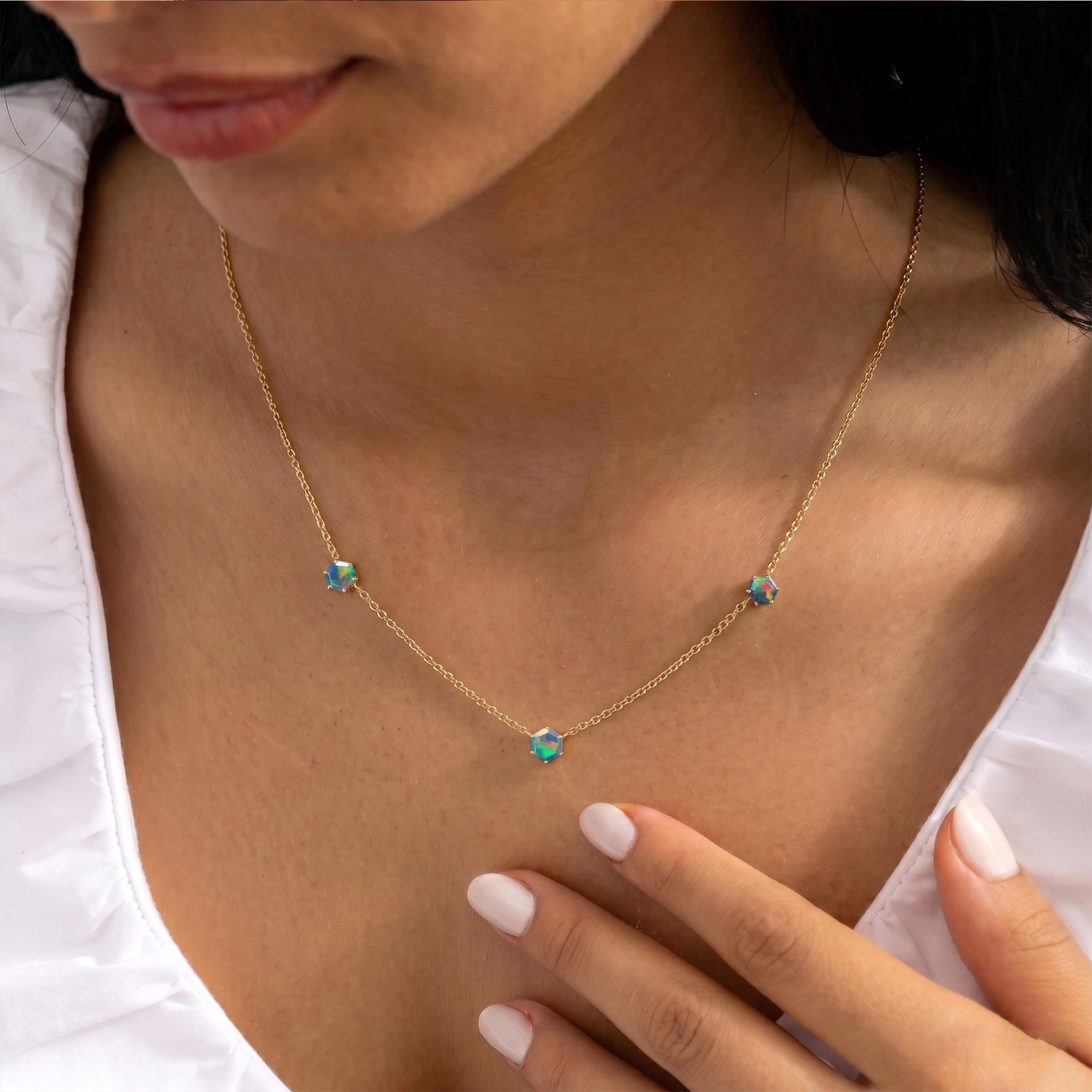 Three Stone Black Opal station necklace featuring 6mm hexagon-cut gemstones in 925 sterling silver with yellow gold filled finish.
