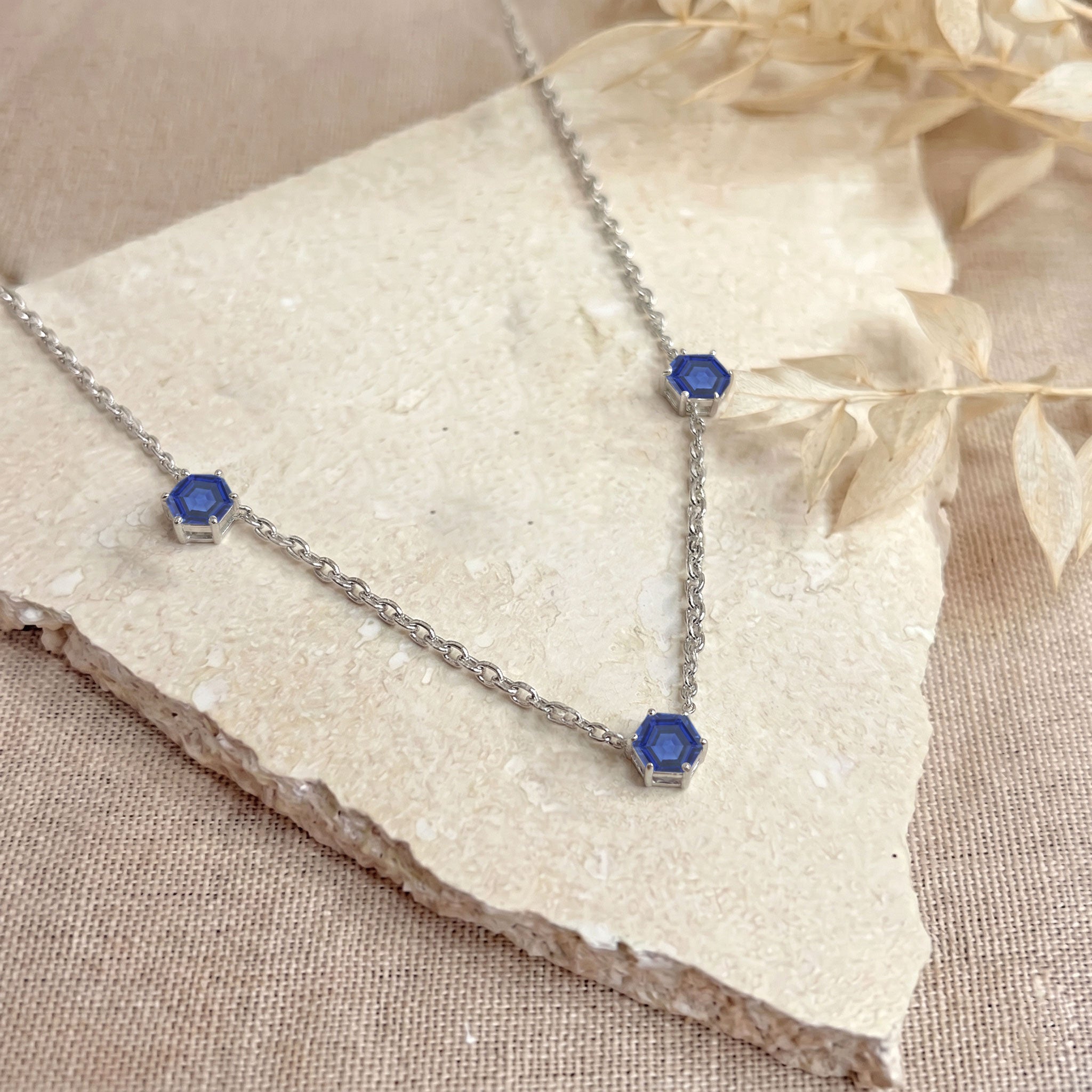 Yellow gold filled blue sapphire three stone necklace with elegant gemstone settings
