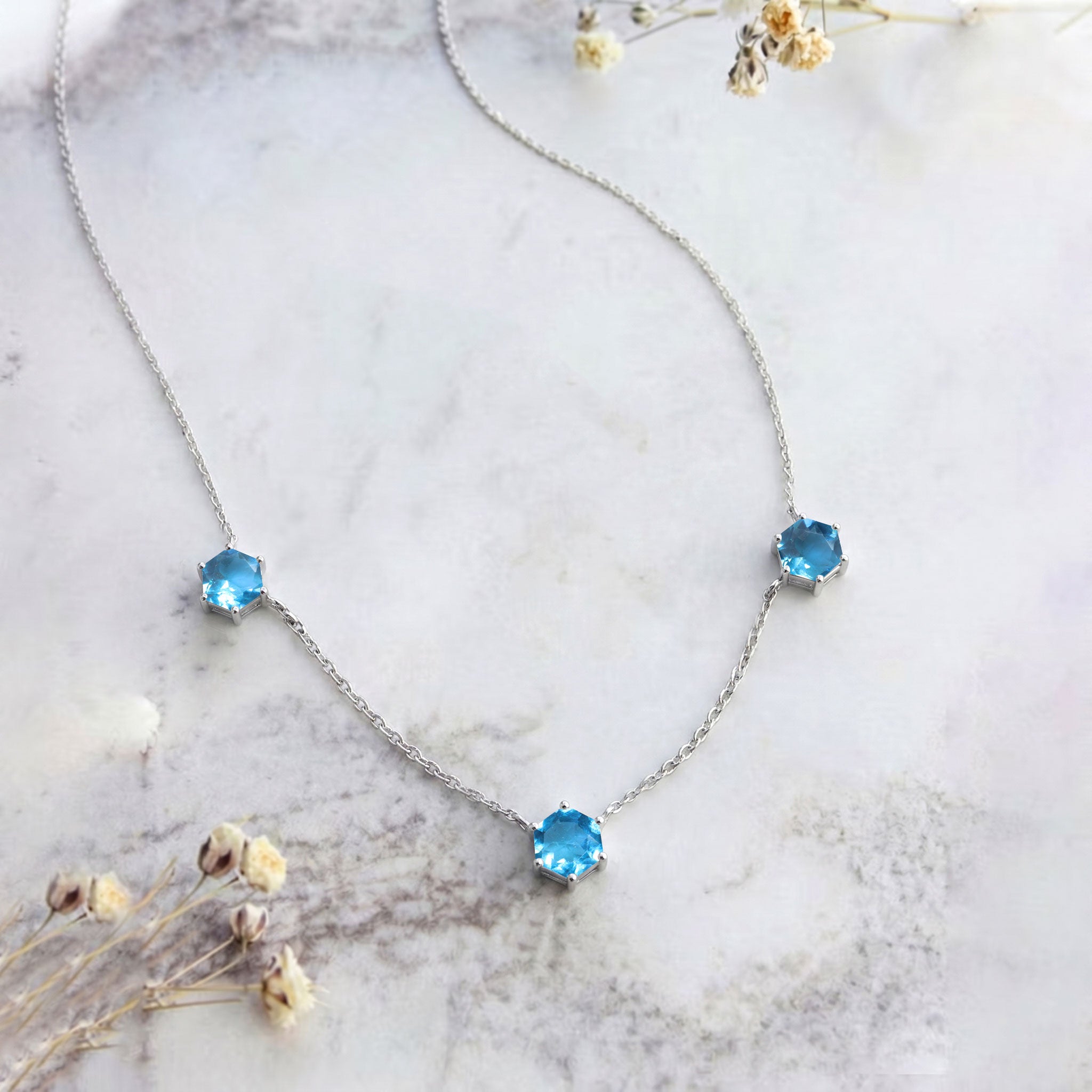 Yellow gold filled blue topaz three stone necklace with luxury gemstone settings
