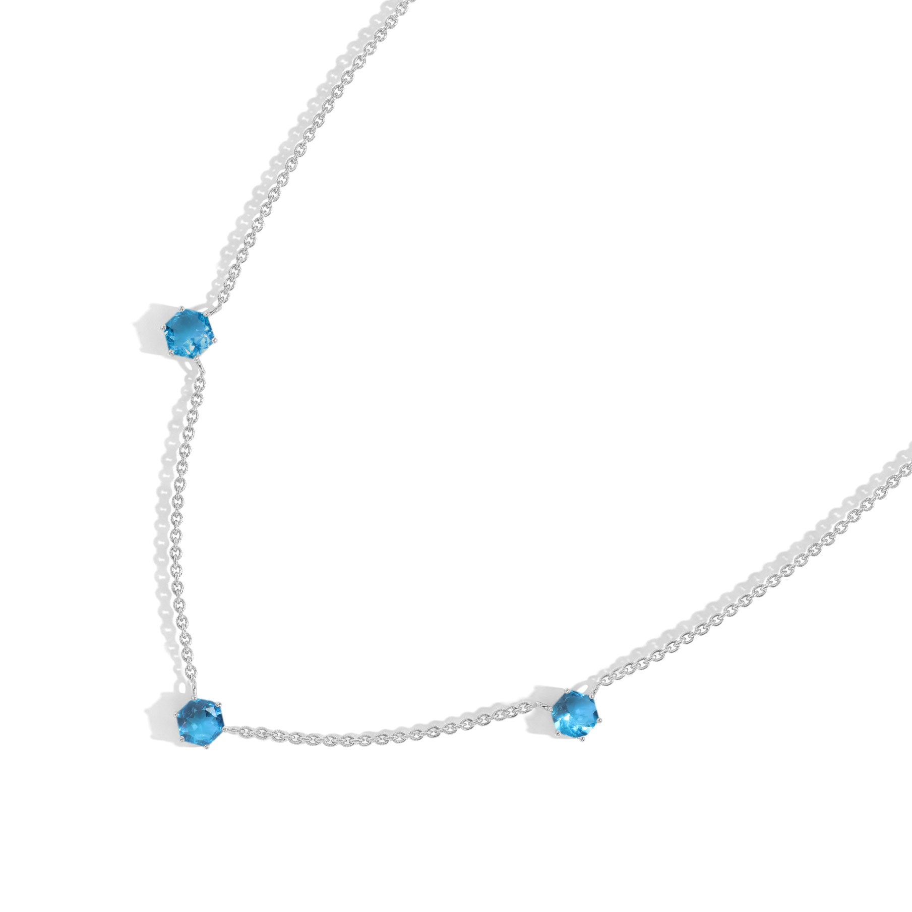 Handmade blue topaz station necklace featuring elegant three gemstone arrangement
