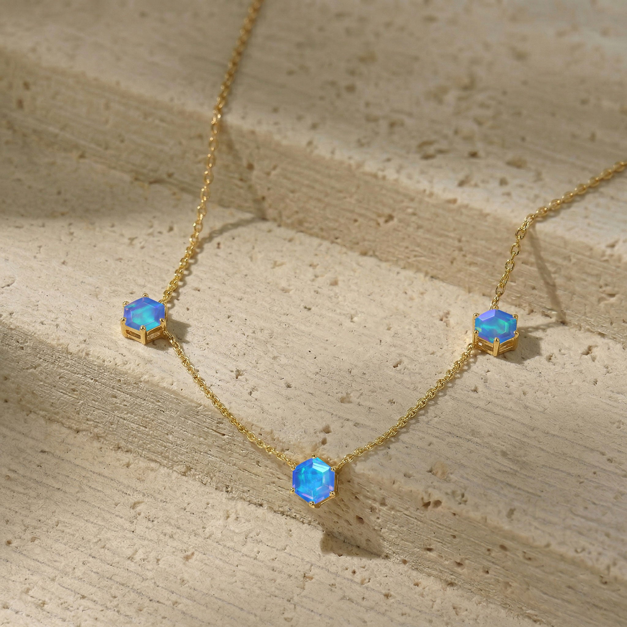 Yellow gold filled blue opal station necklace with three gemstone settings
