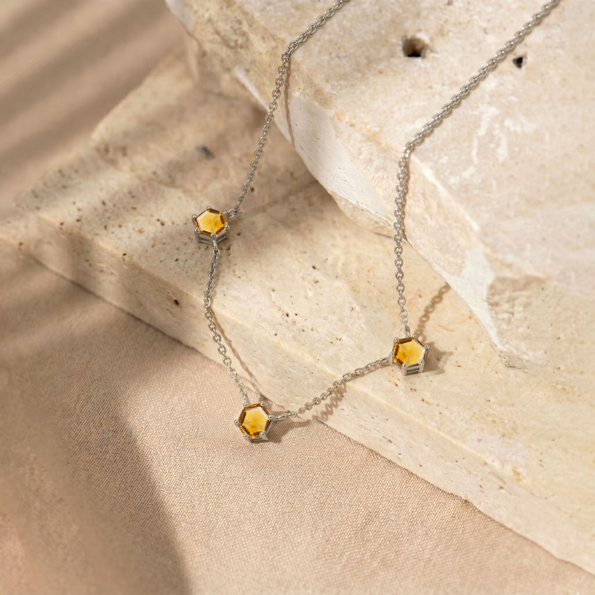 Citrine station necklace with three 6mm hexagon cut citrine gemstones and adjustable chain
