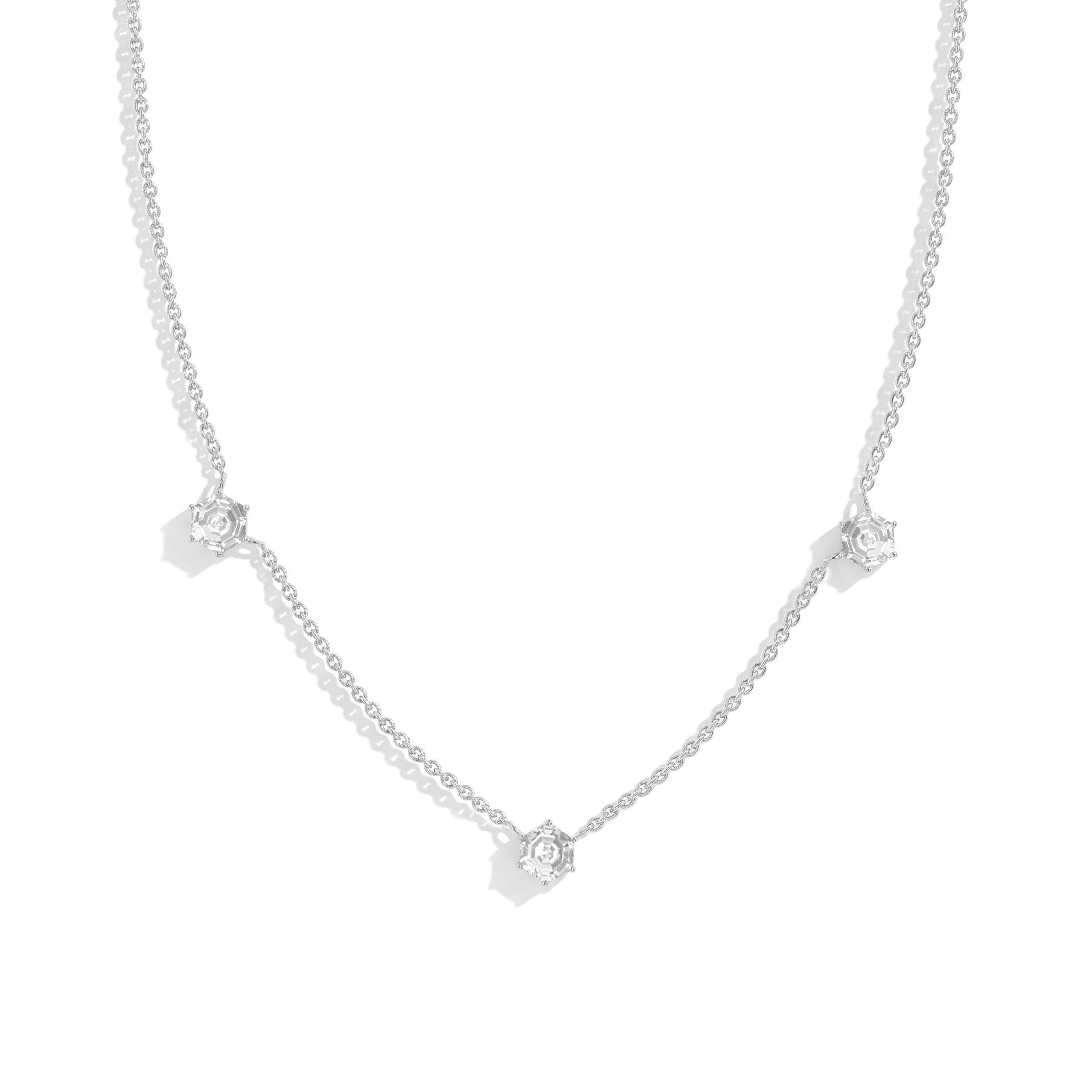 "Three stone moissanite station necklace featuring hexagon cut gemstones in sterling silver
