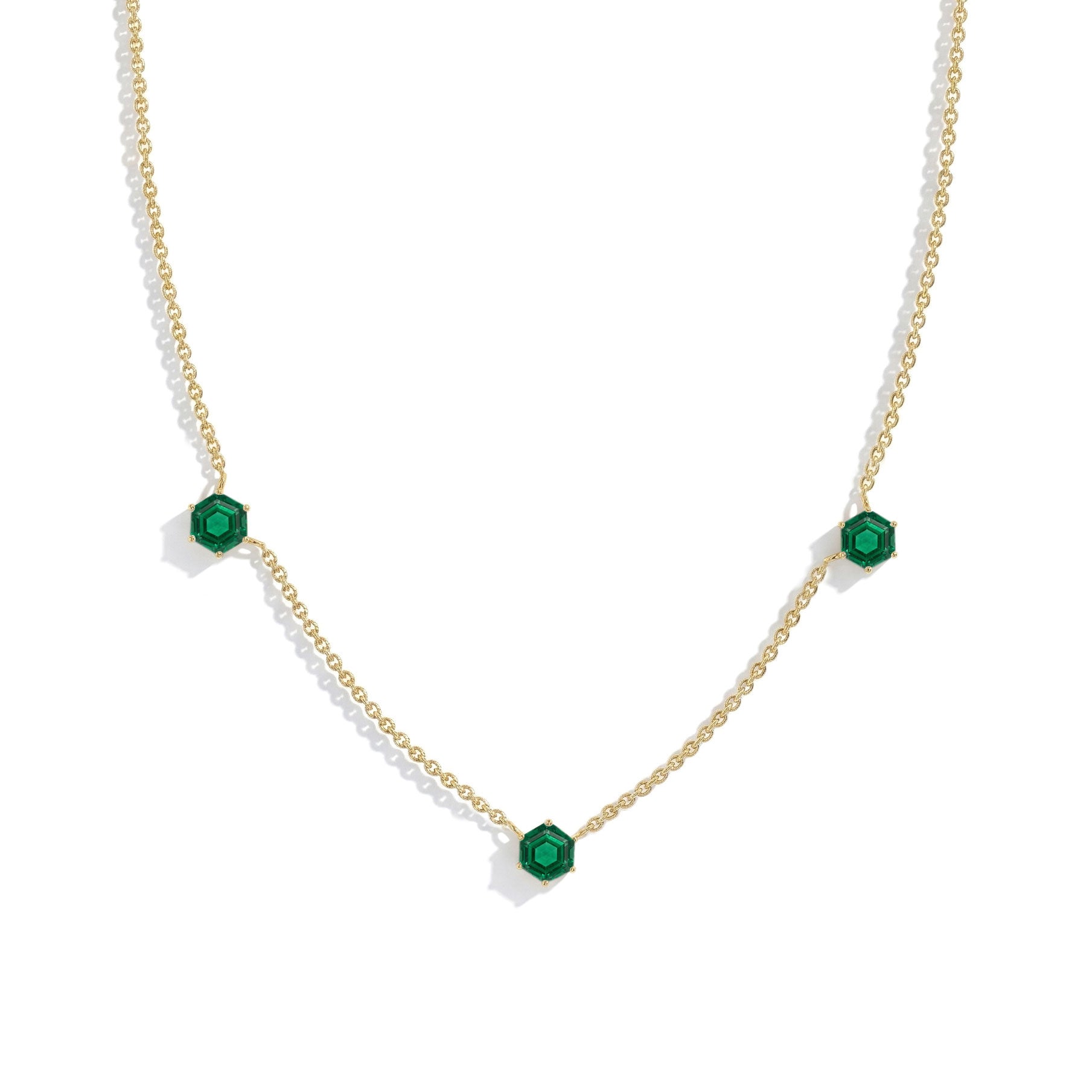 Contemporary Emerald three stone necklace with elegant station chain and classic fine jewelry styling.
