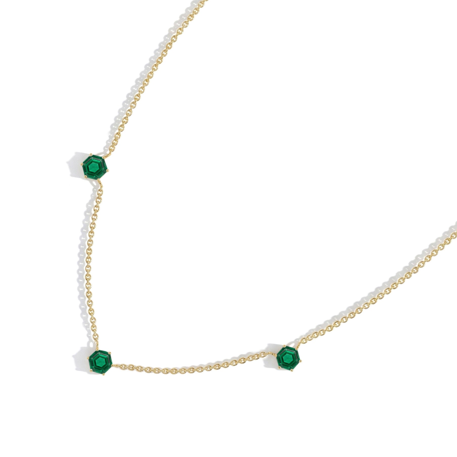 Stylish Emerald necklace for women featuring hexagon-cut gemstones and an adjustable sterling silver chain.
