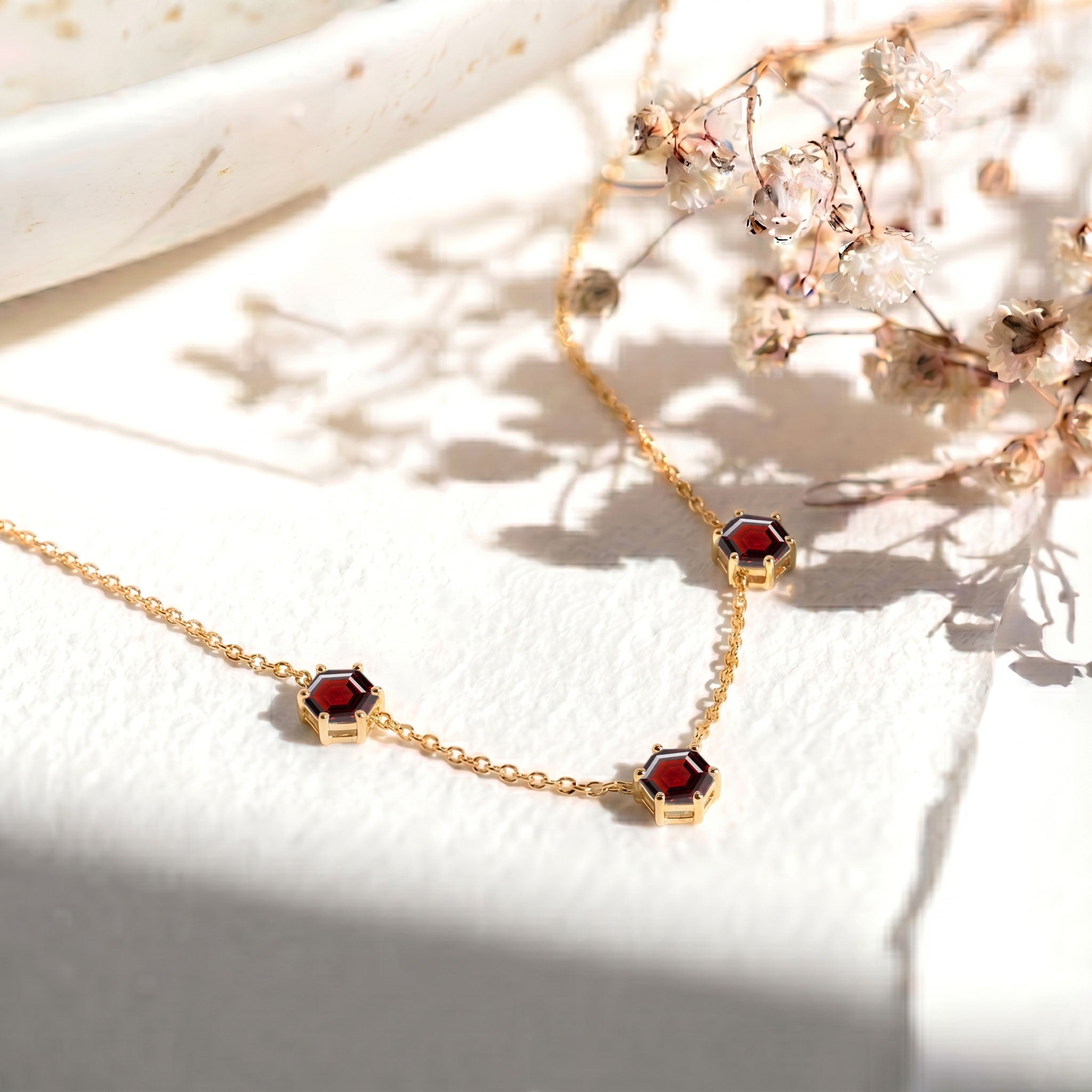 Three gemstone garnet necklace with modern hexagon cut stones and elegant styling
