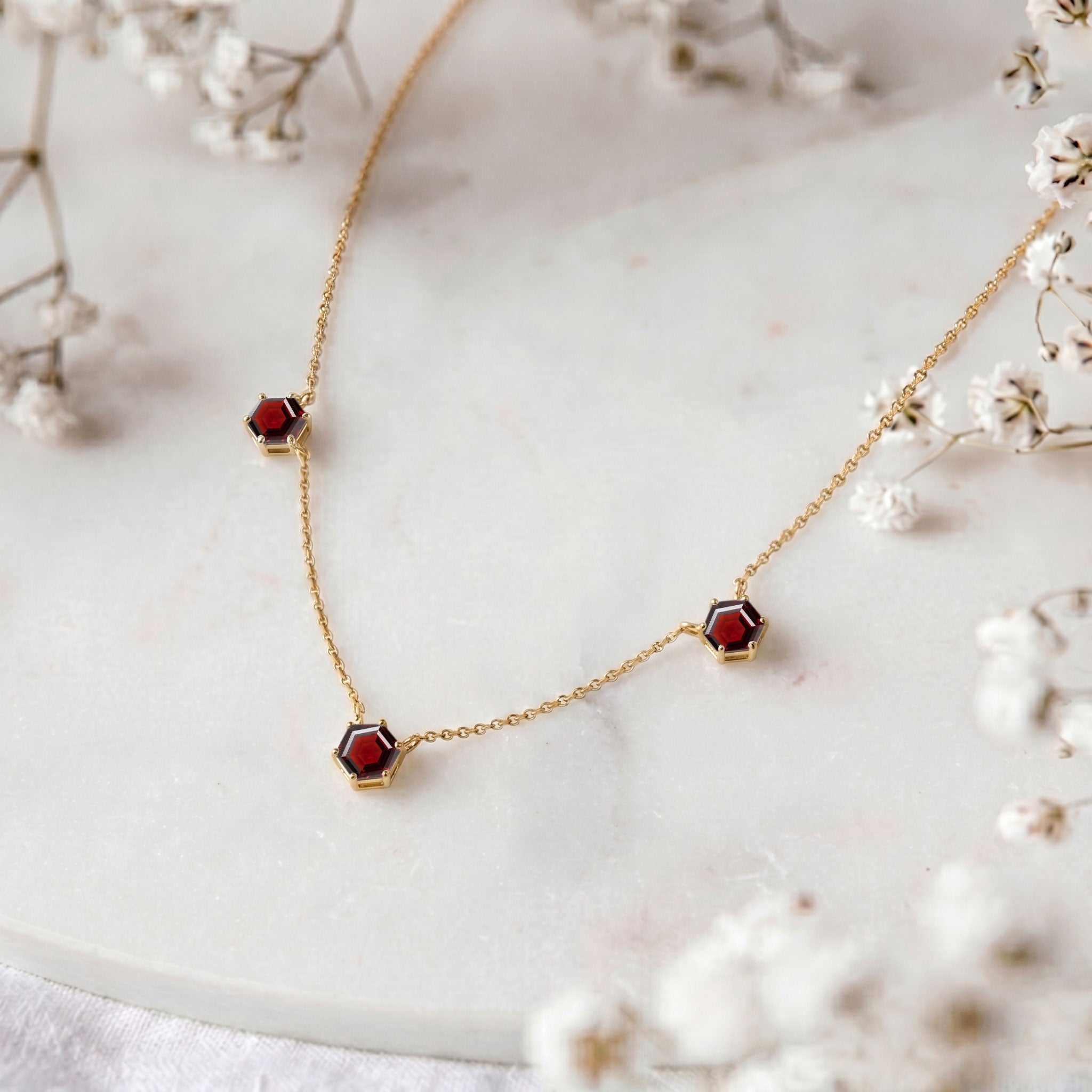 Minimalist garnet station necklace with three red gemstones for everyday wear
