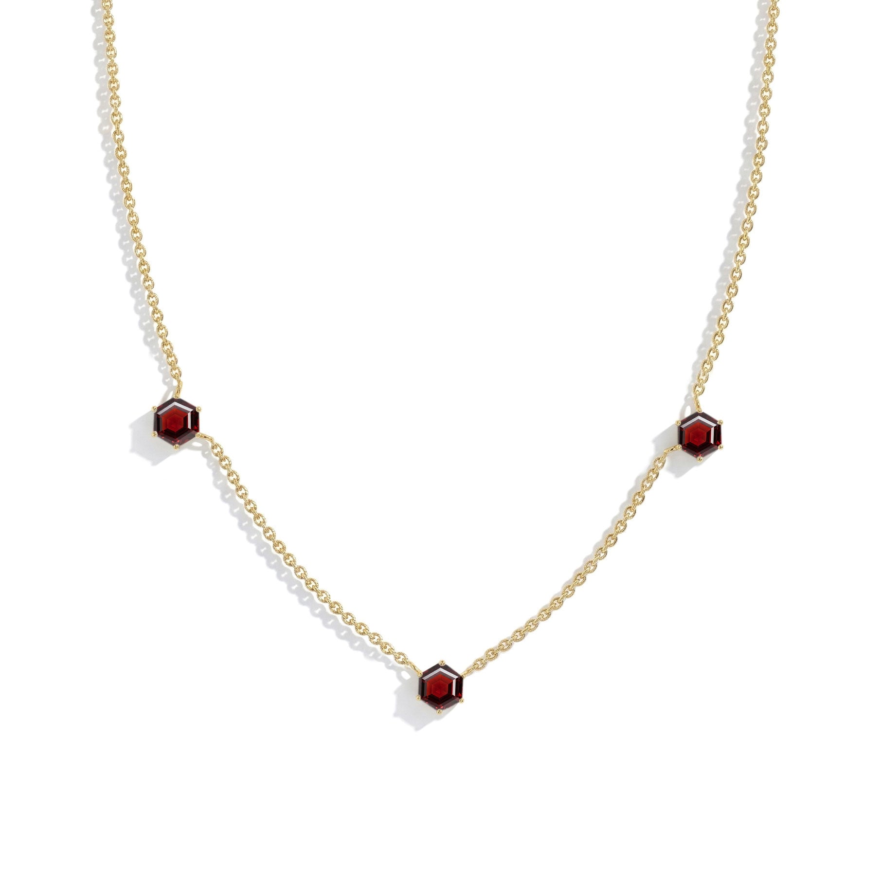 Modern three stone garnet necklace with luxury gemstone details and silver chain
