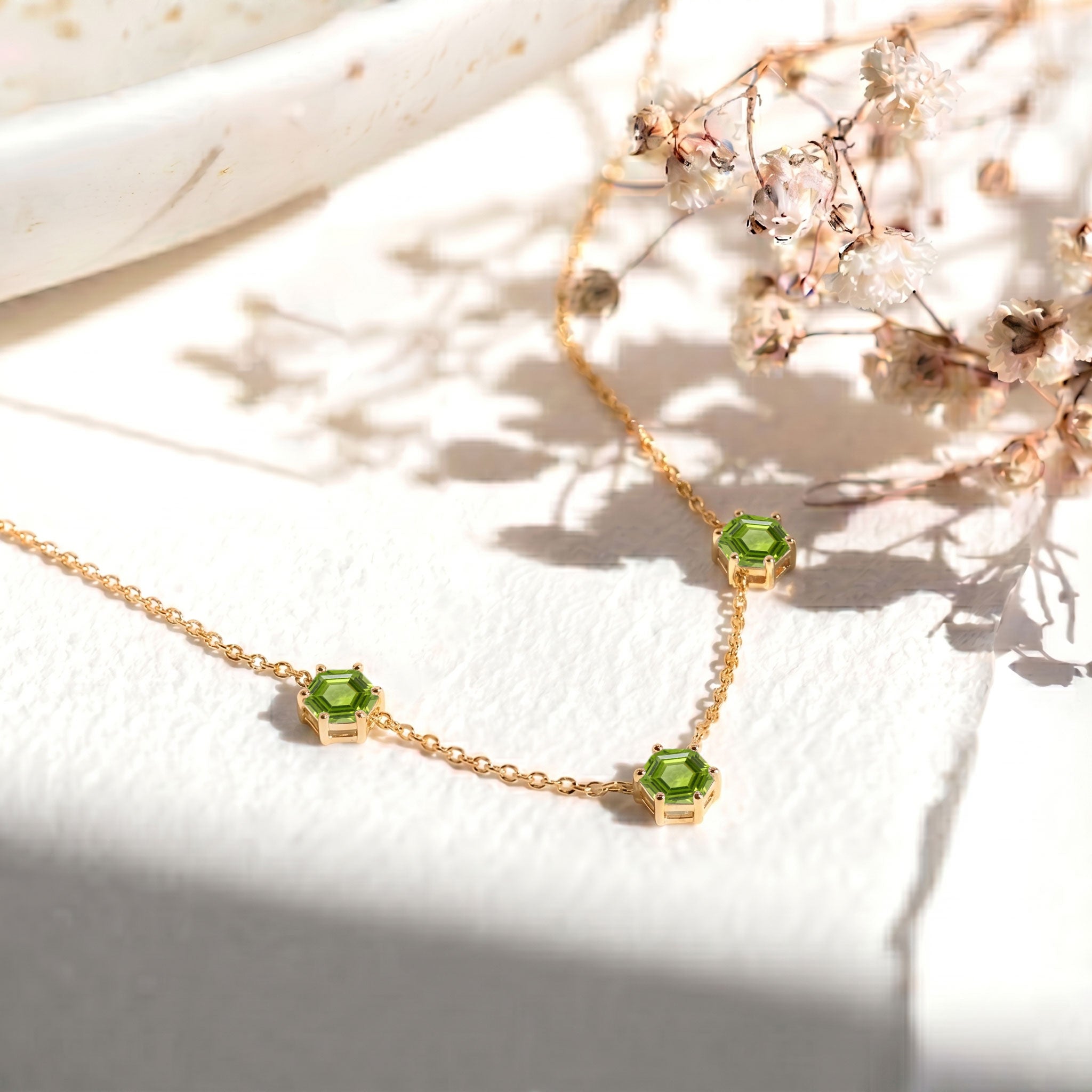 Sterling silver peridot necklace featuring modern station necklace design
