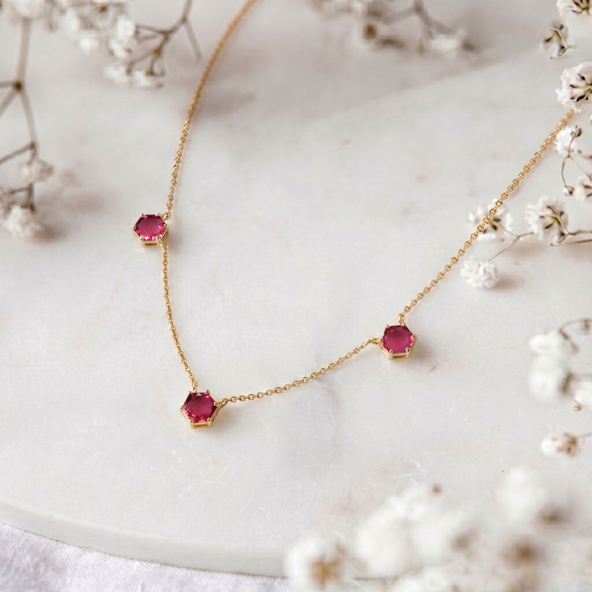 Pink tourmaline gemstone necklace for women with three stone hexagon cut details
