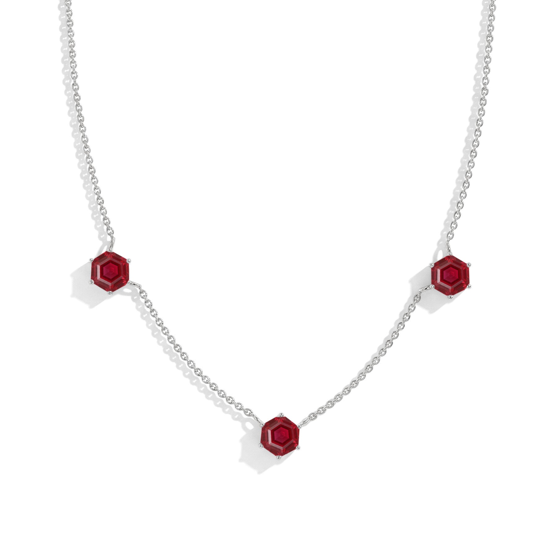 "Three stone ruby station necklace featuring hexagon cut gemstones
