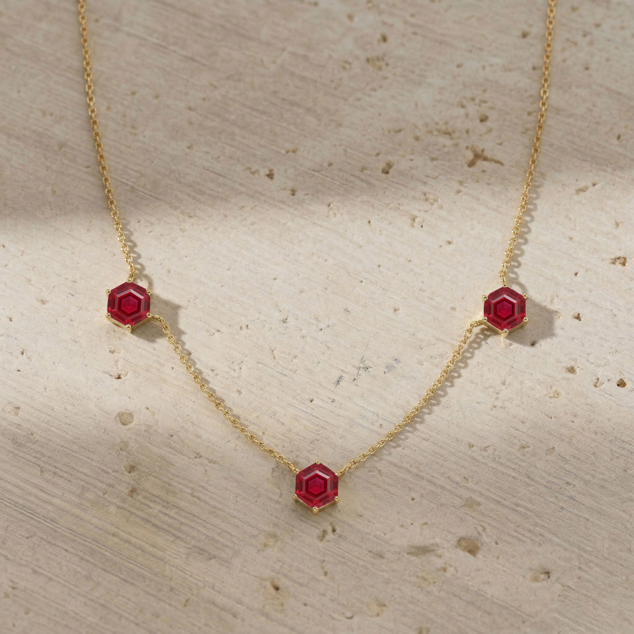 Ruby station necklace with three 6mm hexagon cut gemstones and extender chain
