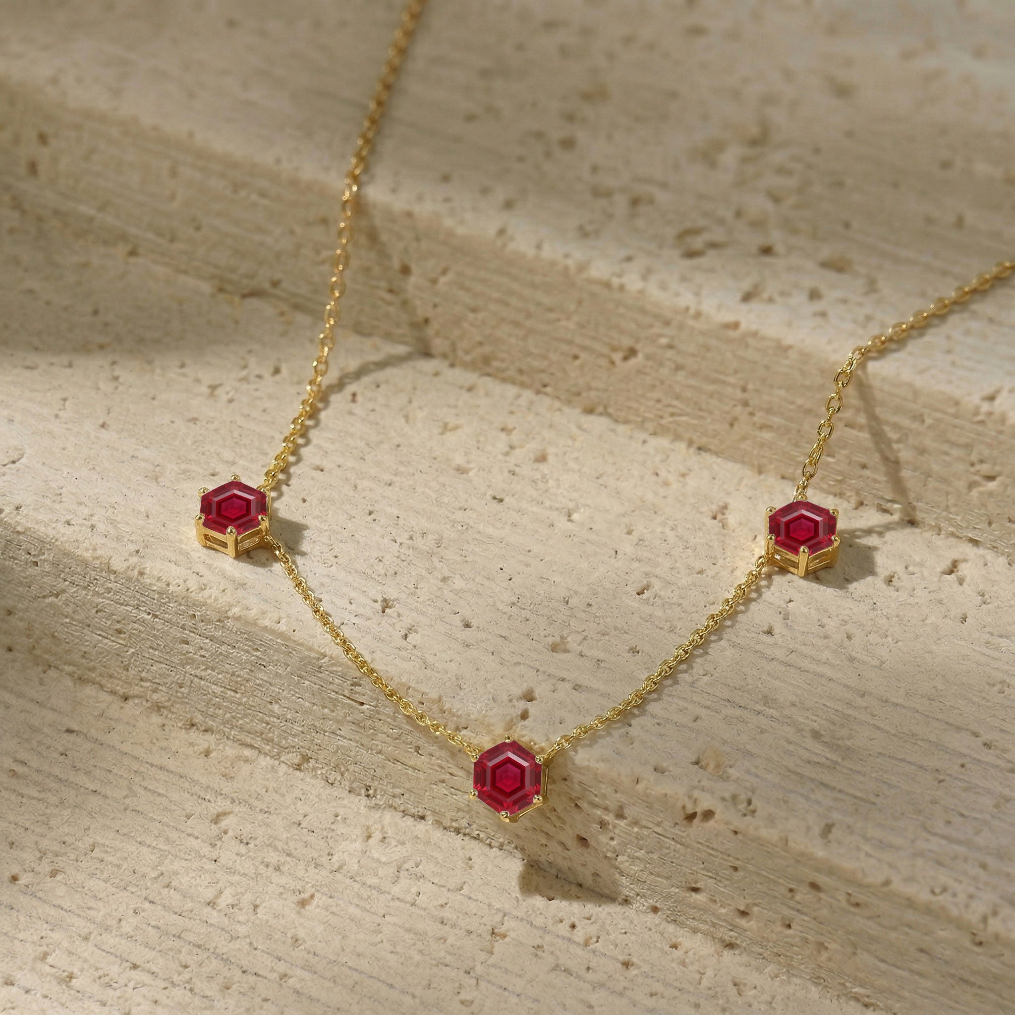 Yellow gold filled ruby three stone necklace with luxury gemstone settings
