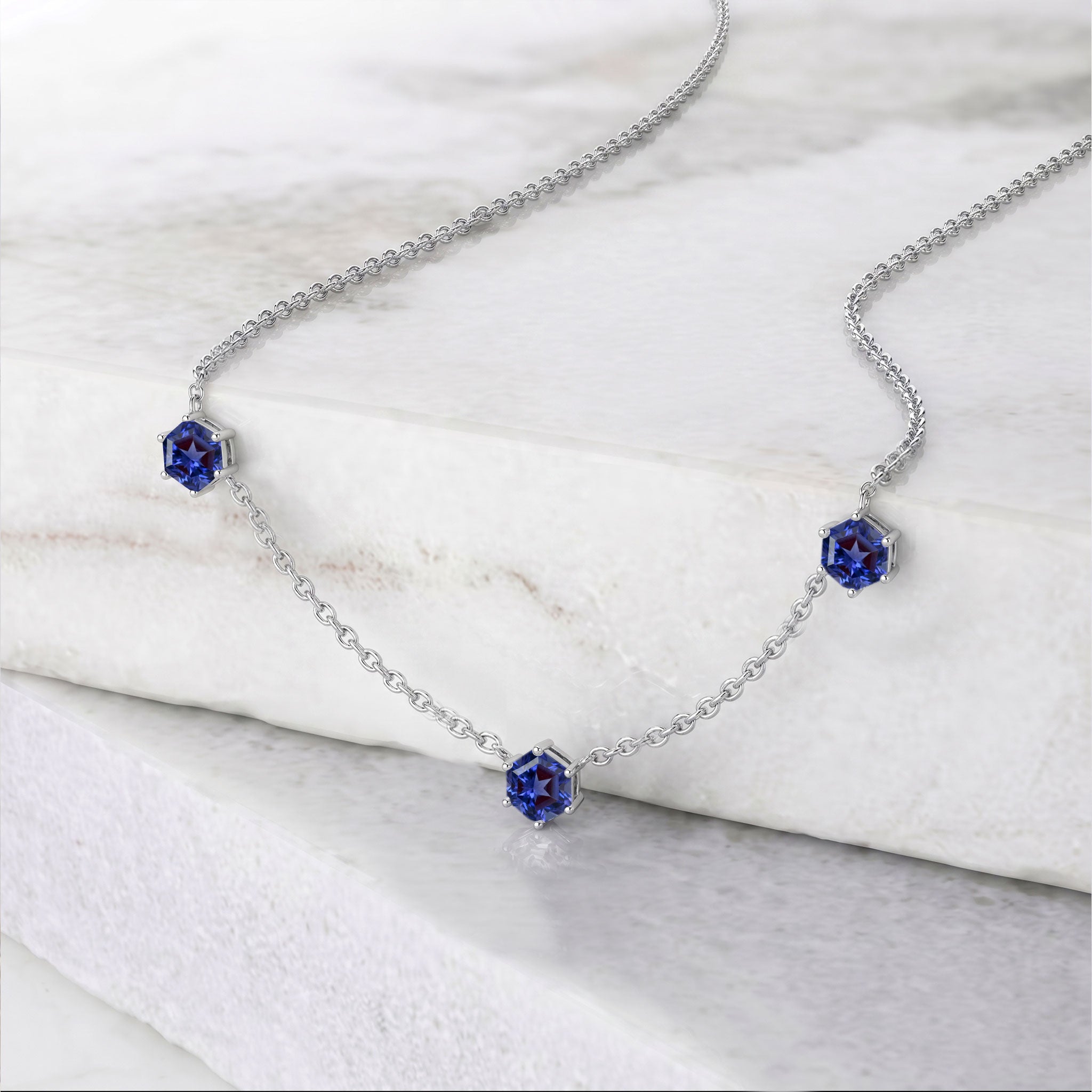 Elegant December birthstone station necklace with three sparkling Tanzanite gemstones.