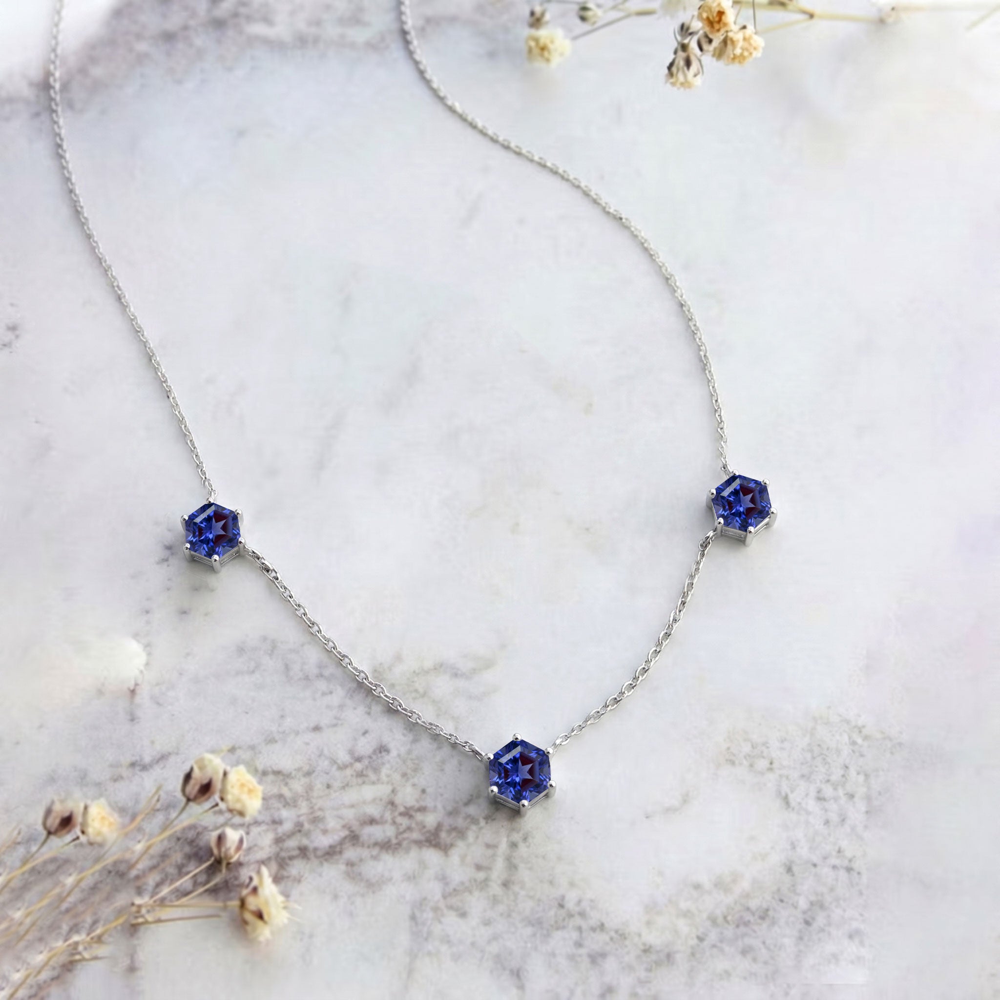 Premium Tanzanite station necklace with modern hexagon gemstone design.