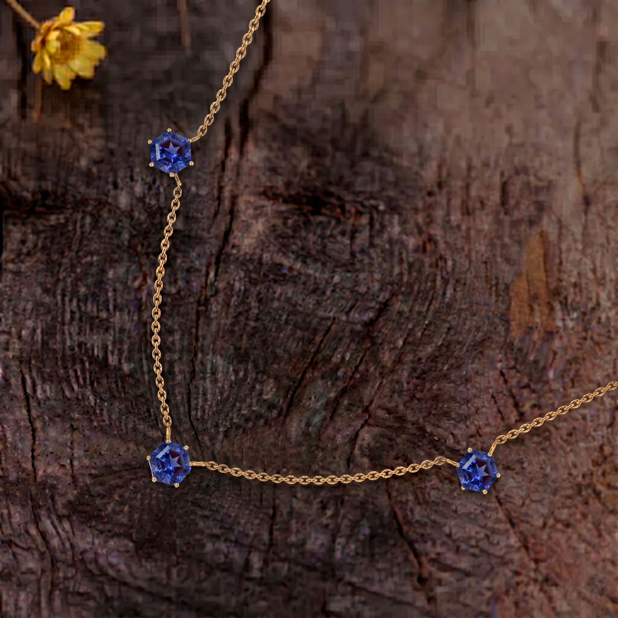 Close-up of genuine Tanzanite gemstones in a three stone station necklace.