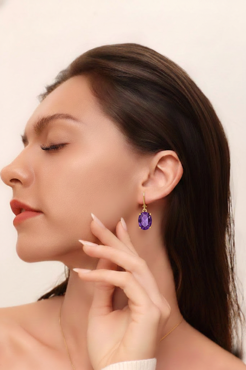 Side angle of a lightweight purple amethyst dangle earring highlighting the smooth 14k gold plated brass ear wire hook