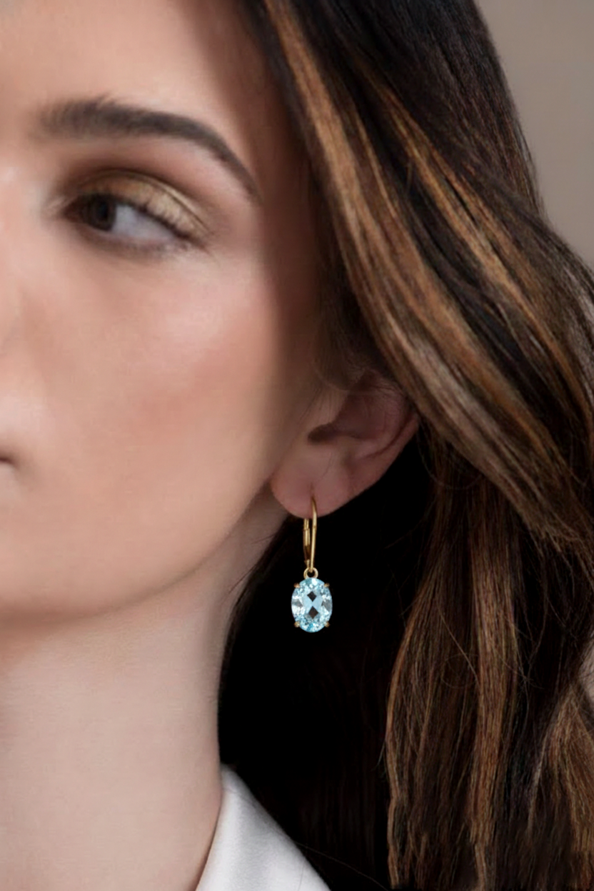 Premium March birthstone jewelry designed as a lightweight and stylish blue gemstone gift for her. Detailed close-up of 8x6mm AAA lab aquamarine gemstone set in 14K gold plated brass prongs.