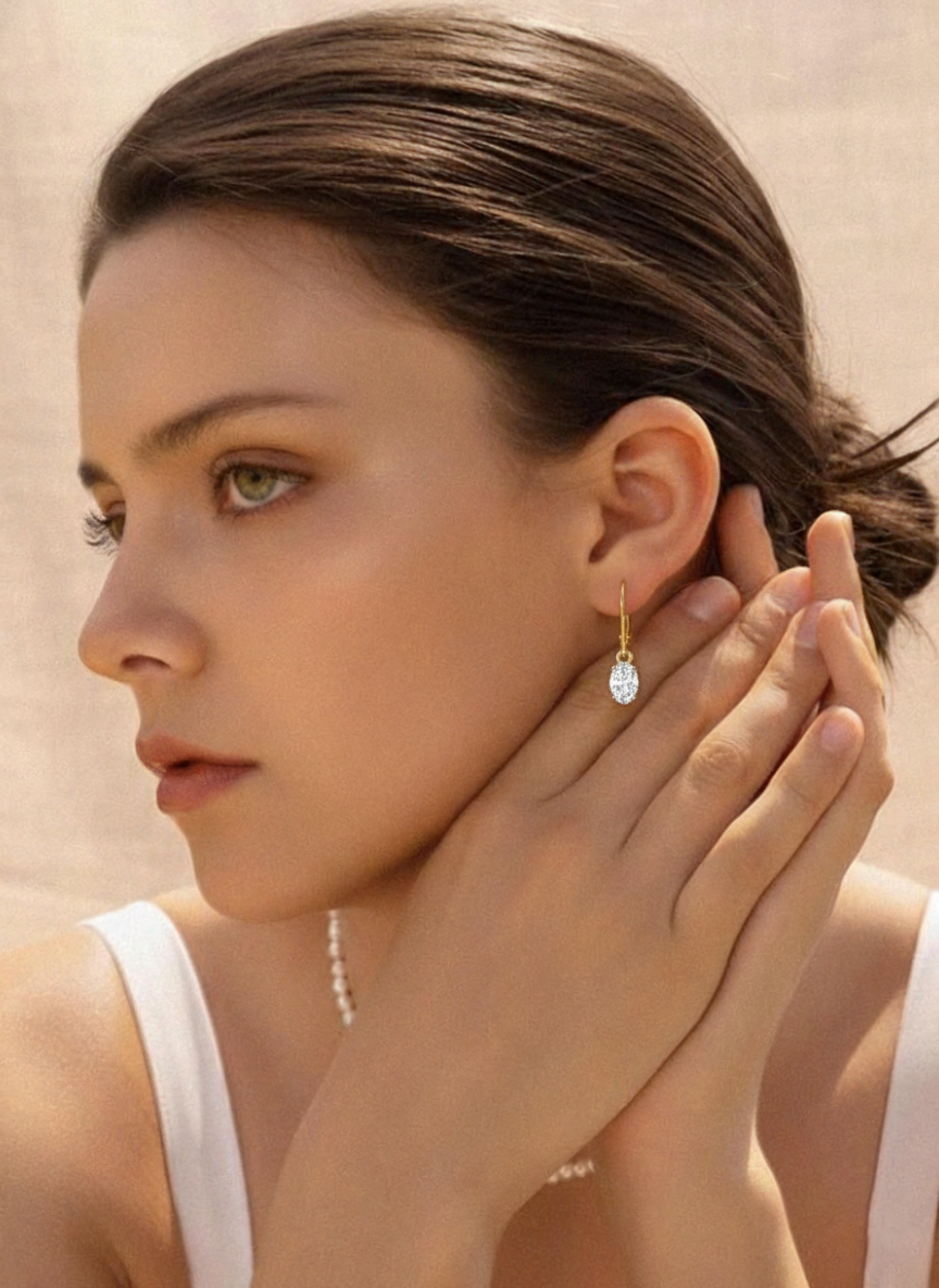 14K gold plated oval cubic zirconia dangle drop earrings featuring twin AAA lab white gemstones in an elegant leverback style.