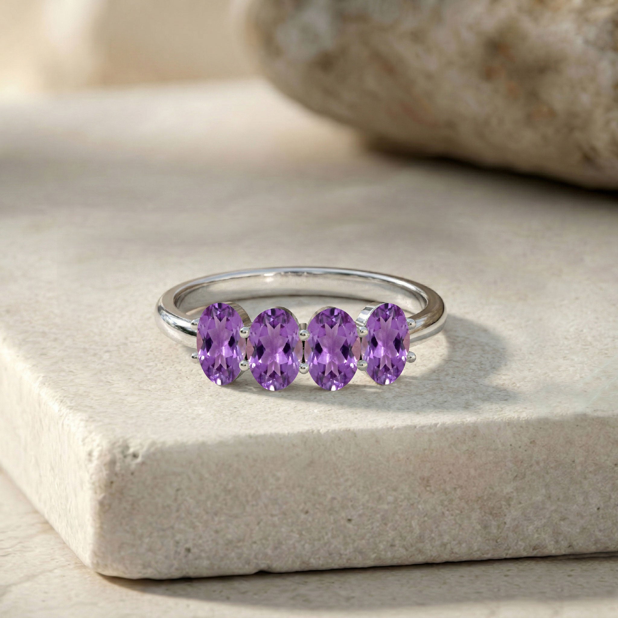 luxury amethyst jewelry, natural gemstone ring, oval gemstone arrangement, vibrant purple sparkle, artisan craftsmanship, stackable fine ring, polished band design, timeless jewelry collection, feminine gemstone accessory, premium gift idea