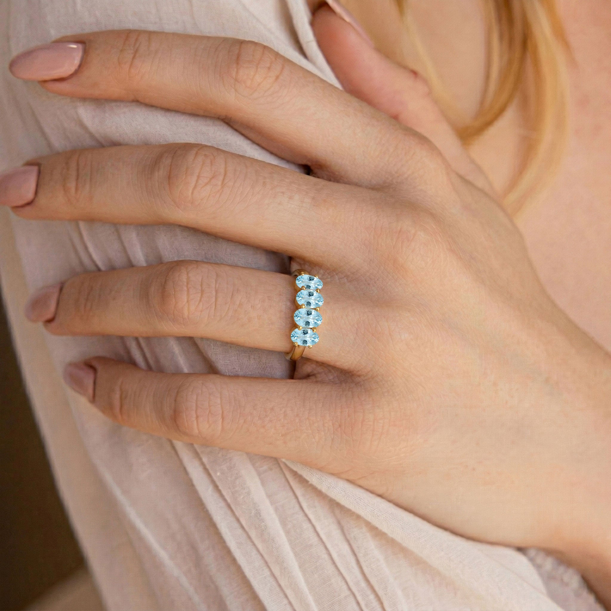 horizontal aquamarine ring, faceted oval gemstone, blue stone jewelry, contemporary ring, sleek band, minimalist fashion jewelry, stackable gemstone ring, birthday gift for women, classic jewelry, elegant accessory, fine craftsmanship, gemstone fashion