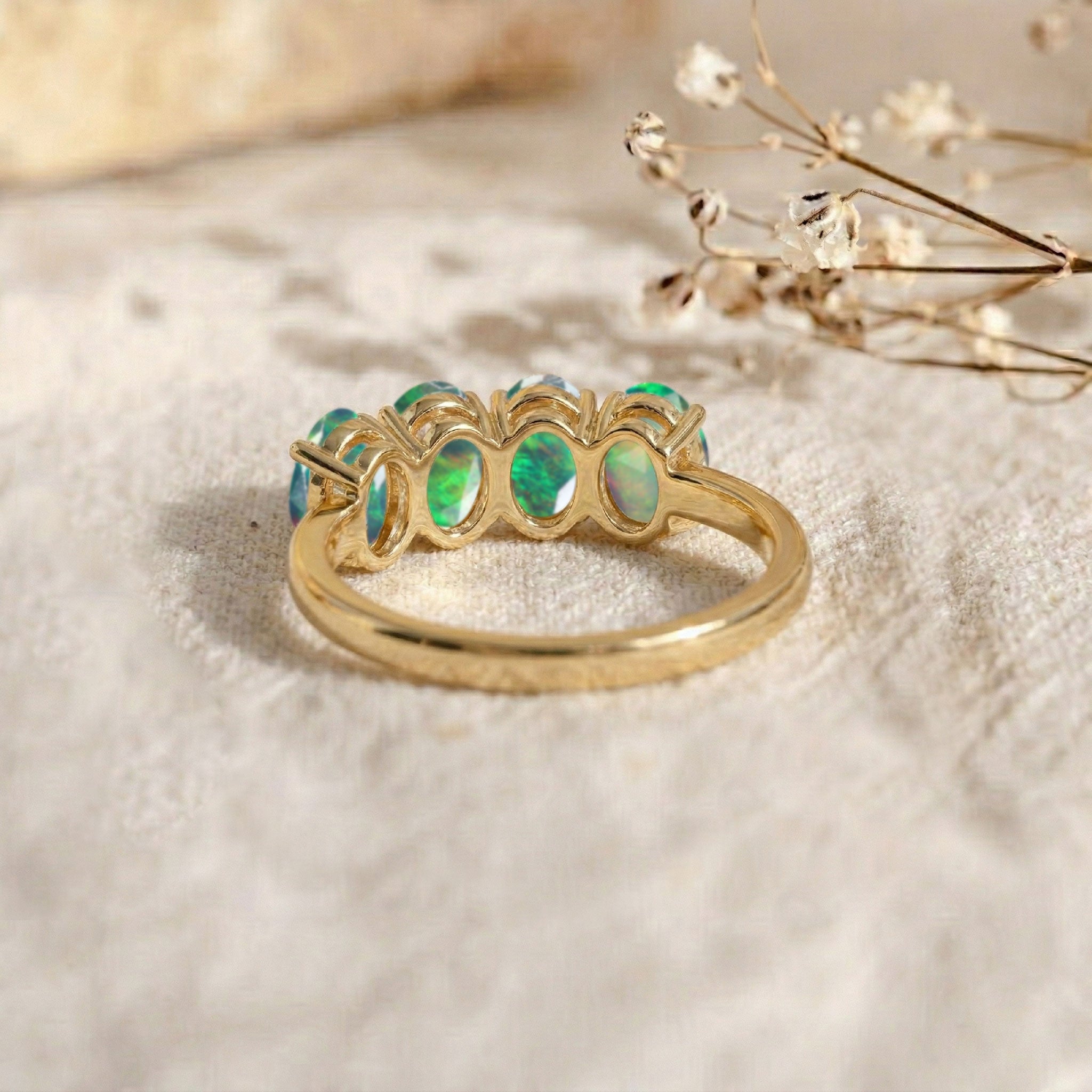 designer black opal ring, genuine gemstone jewelry, luxury four stone band, elegant oval gemstone setting, premium handcrafted accessory, colorful natural opal brilliance, refined women's jewelry, October birthstone gift, timeless stacking ring, artisan luxury craftsmanship, sophisticated everyday elegance, statement gemstone ring