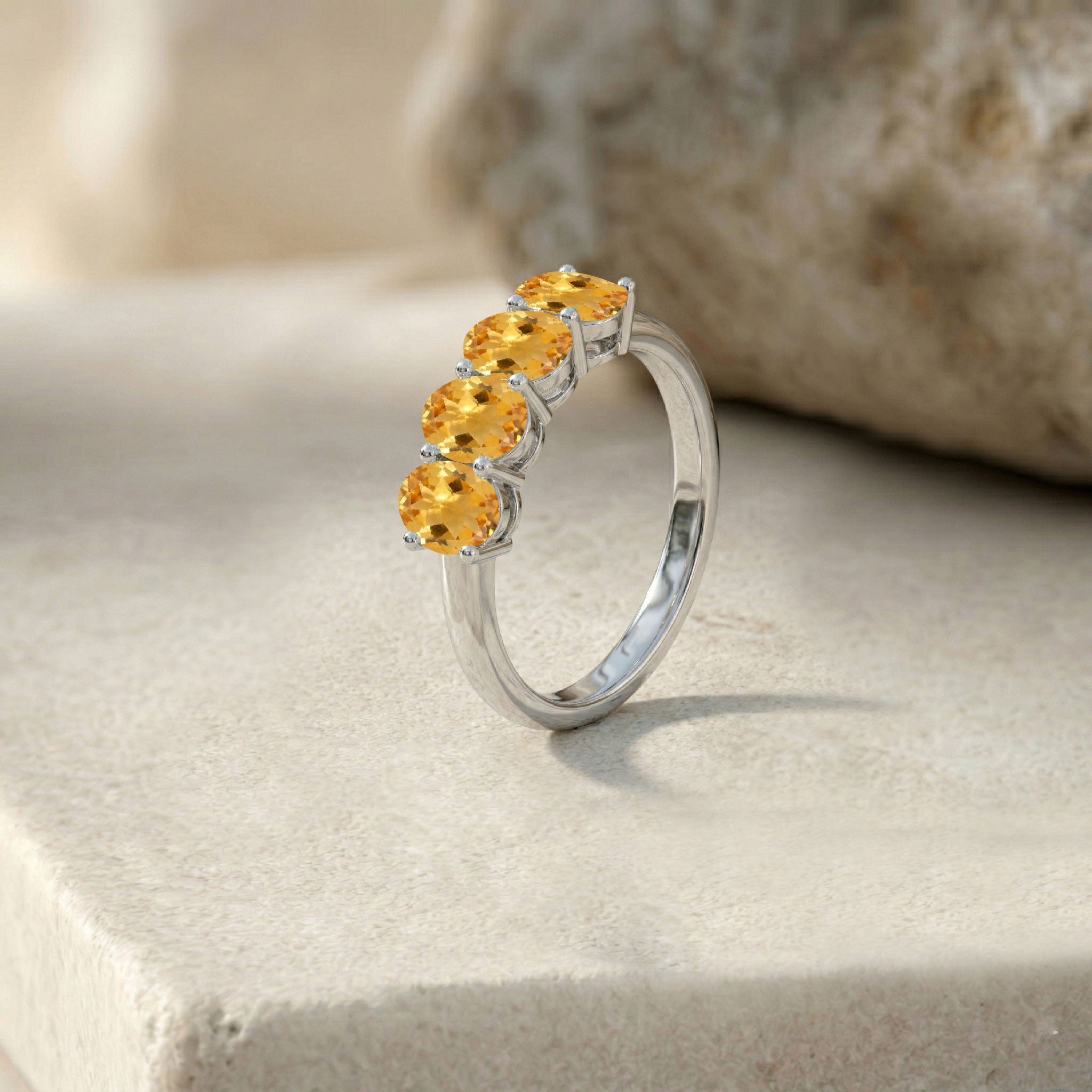 sterling silver gemstone ring, polished band jewelry, brilliant citrine gemstones, horizontal gemstone design, fashionable stacking ring, modern elegance, delicate handcrafted jewelry, oval birthstone ring, luxury fashion accessory, women's ring