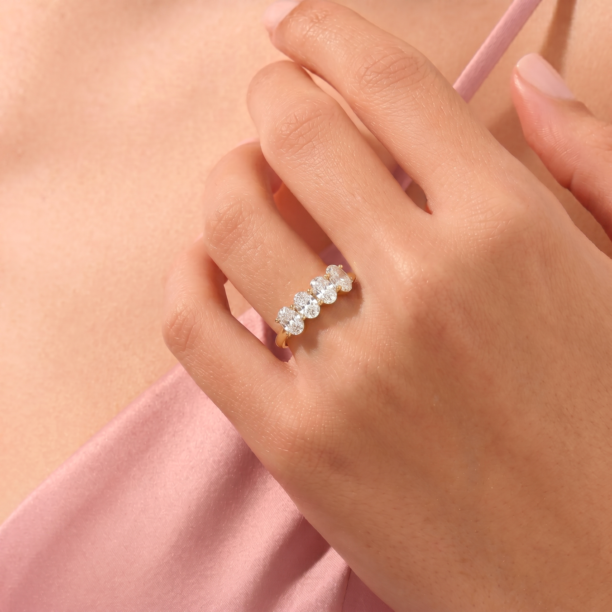oval gemstone jewellery, brilliant four stone ring, moissanite fashion ring, minimalist luxury, timeless bridal ring, elegant women's accessory, handcrafted gemstone jewellery, stacking band, everyday sophistication, polished craftsmanship, jewellery gift, modern style