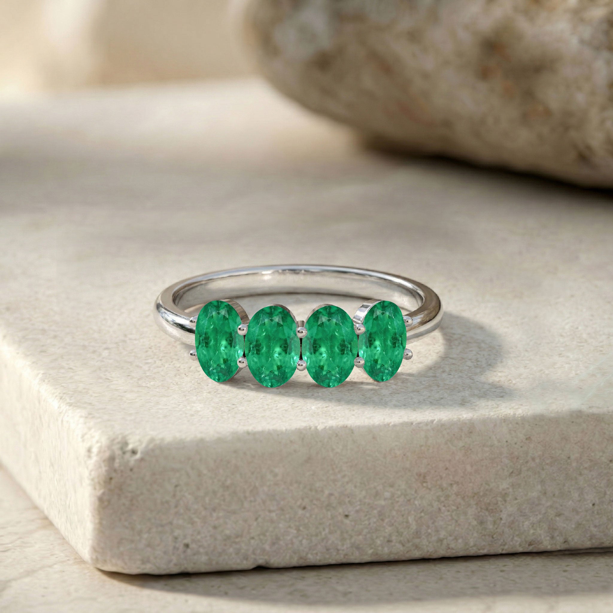 green gemstone jewelry, emerald stackable ring, refined band design, sophisticated gift, bridal fashion ring, oval gemstone setting, elegant handmade ring, contemporary jewelry style, polished finish, luxury everyday ring, women's accessory, unique design